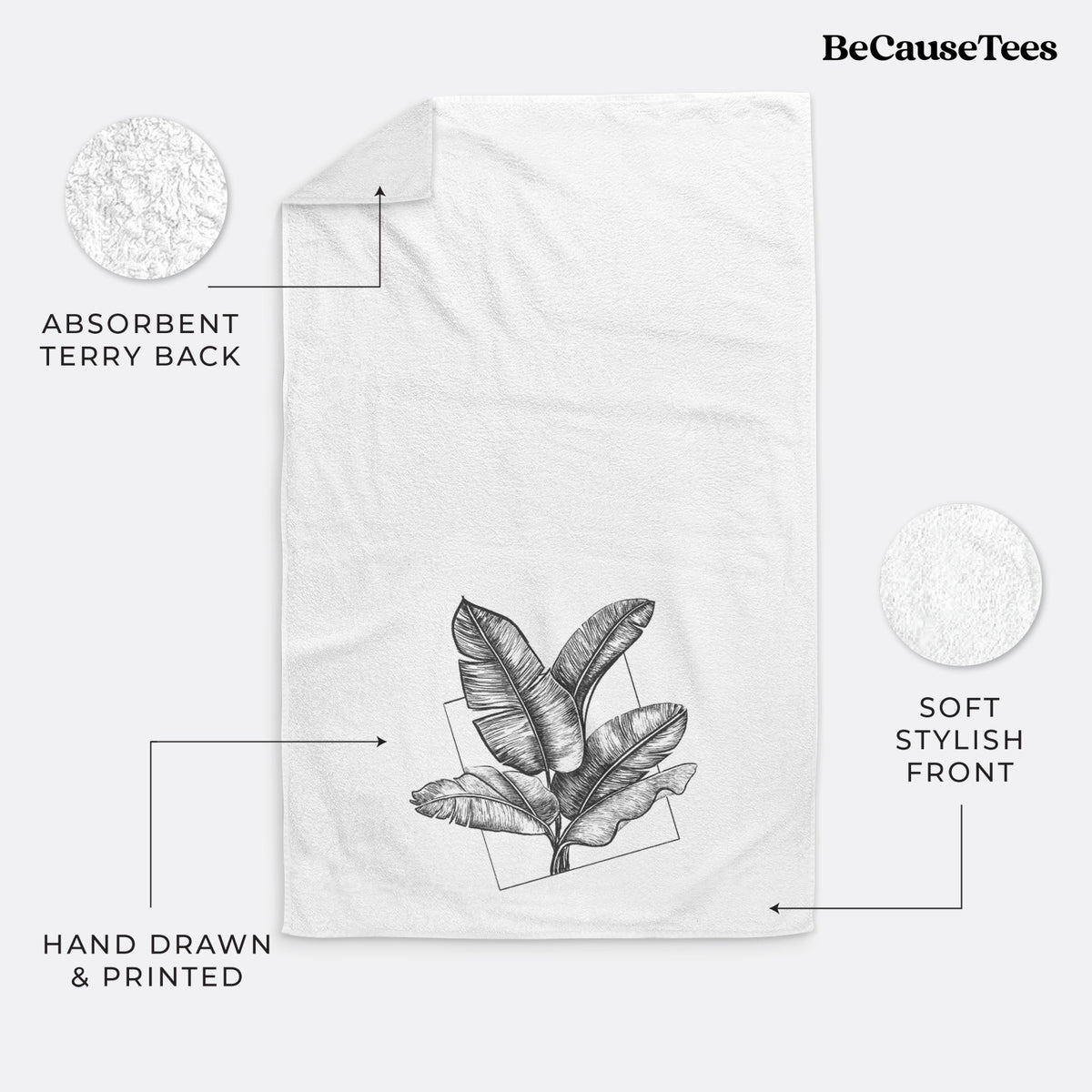 White hand towel printed with a black ink illustration of banana leaves in front of a square outline.