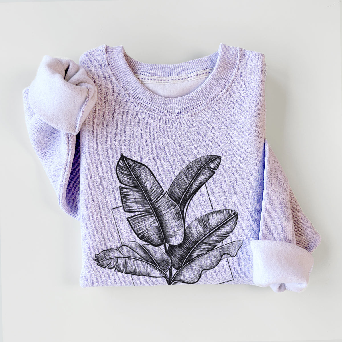 Ice purple knit sweatshirt printed with a black ink illustration of banana leaves in front of a square outline, styled flat.