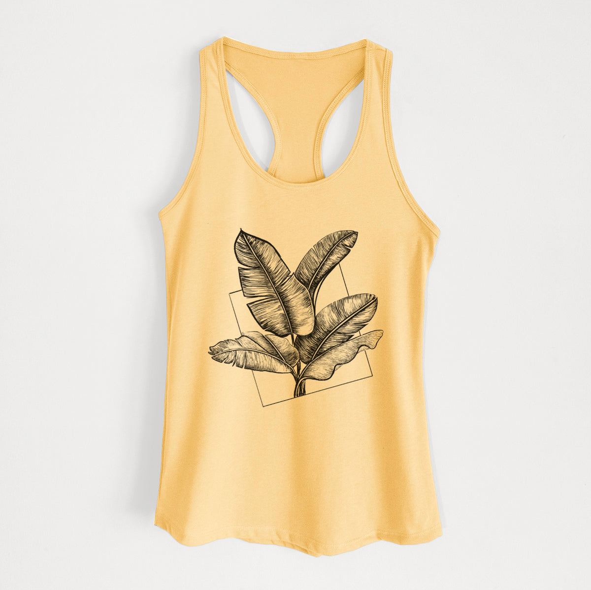 Banana cream women's racerback tank top laid flat, printed with a black ink illustration of banana leaves in front of a square outline.