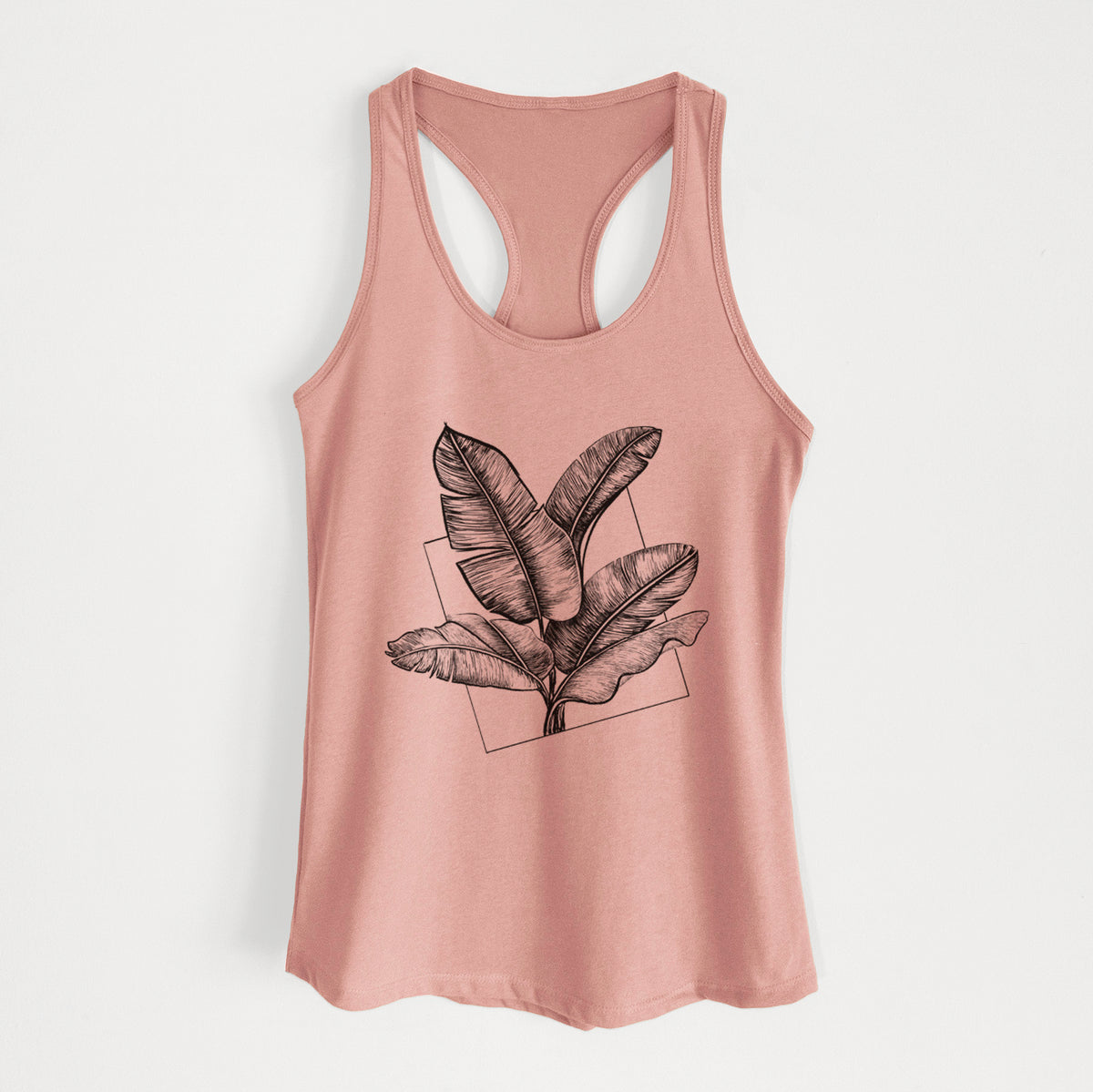 Desert pink women's racerback tank top laid flat, printed with a black ink illustration of banana leaves in front of a square outline.