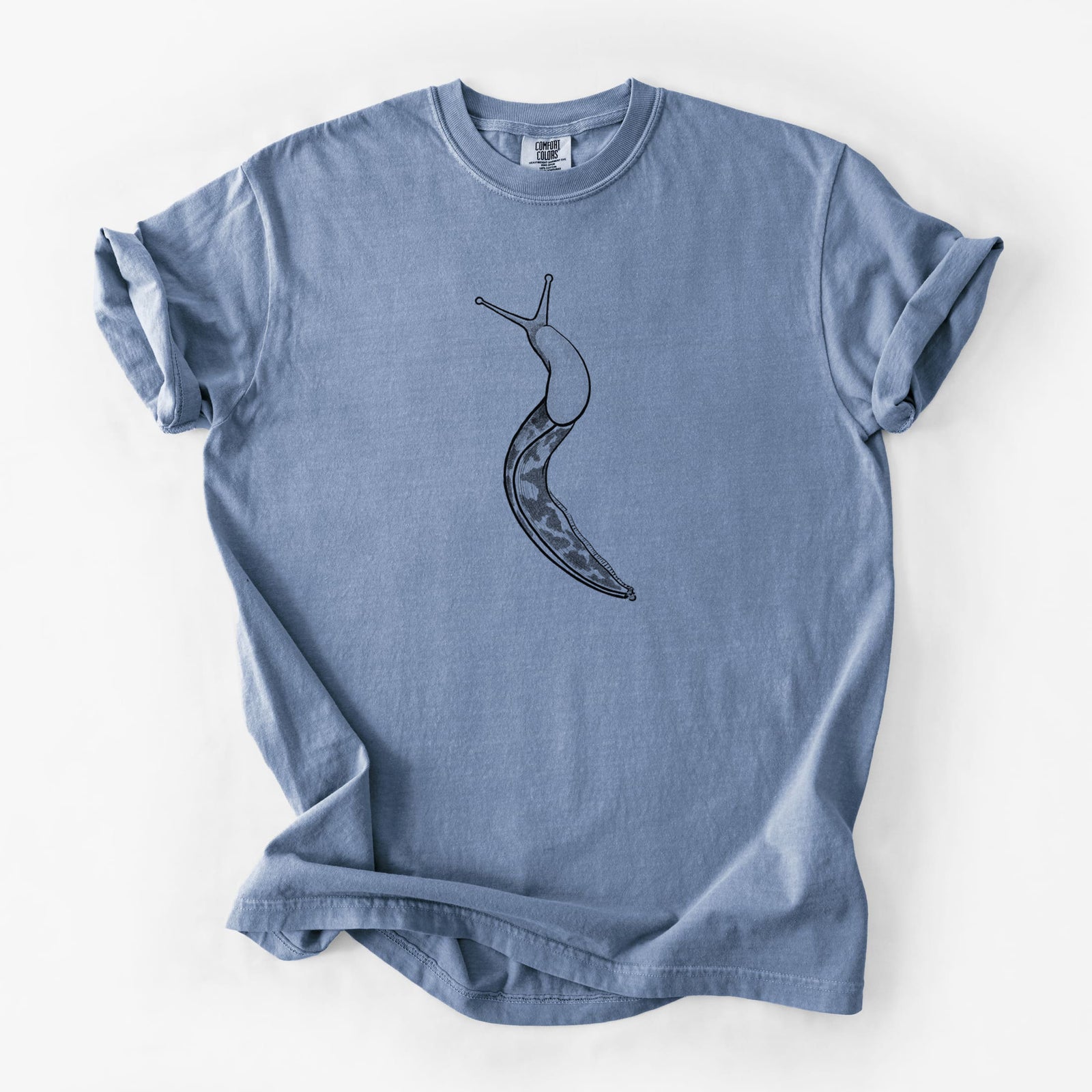 Blue jean Comfort Colors t-shirt laid flat, printed with a detailed black ink illustration of a spotted banana slug with its eyestalks raised.