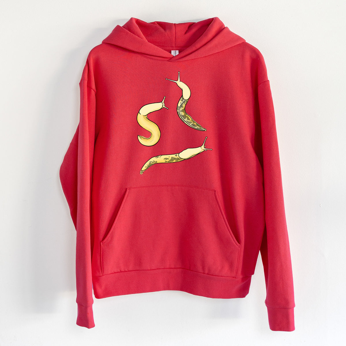 Banana Slug Squad - Ariolimax columbianus - Statement Midweight Hoodie in Cherry Red, hanging on a white wall, with a front kangaroo pocket and no drawcords.