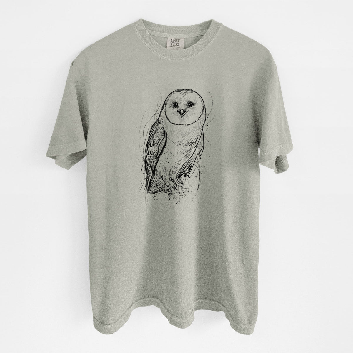 Sandstone beige Comfort Colors t-shirt laid flat, printed with a detailed black ink illustration of a barn owl standing and facing forward.