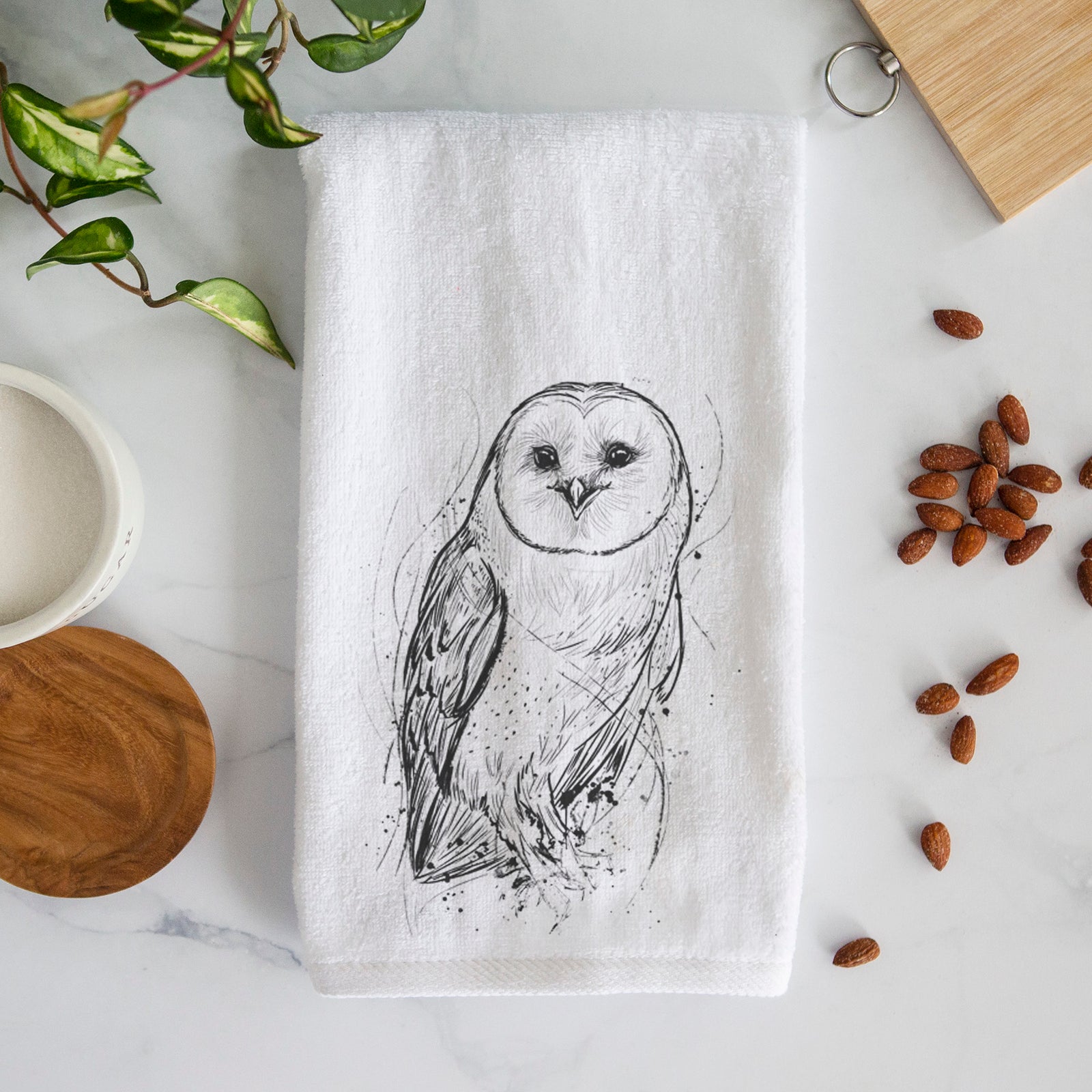 White hand towel printed with a detailed black ink illustration of a barn owl standing and facing forward.