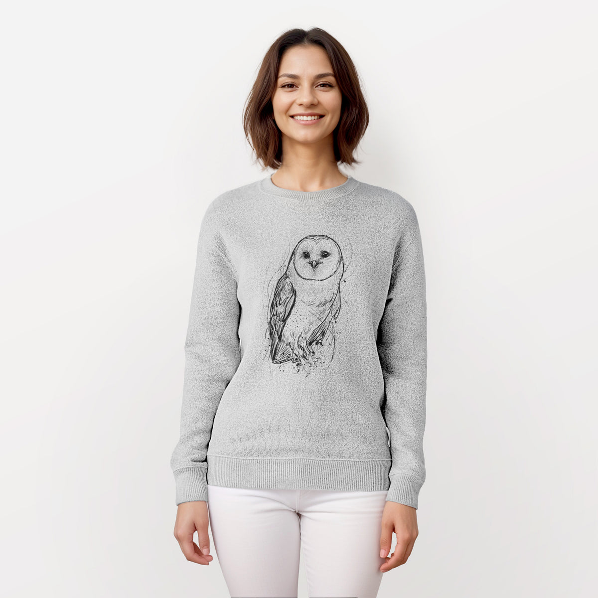 Woman wearing a knit sweatshirt printed with a detailed black ink illustration of a barn owl standing and facing forward.