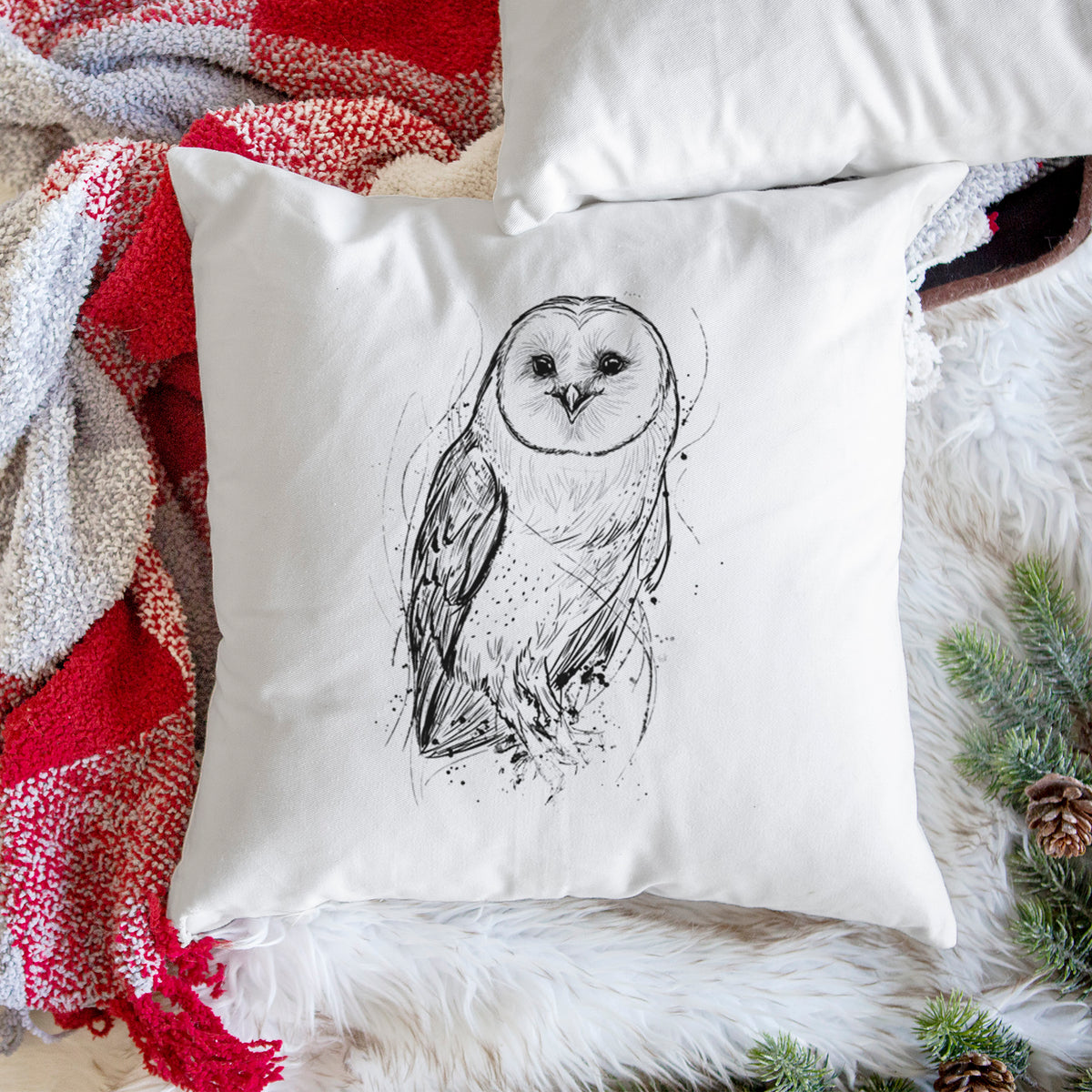White pillow cover printed with a detailed black ink illustration of a barn owl standing and facing forward, on a woven chair.