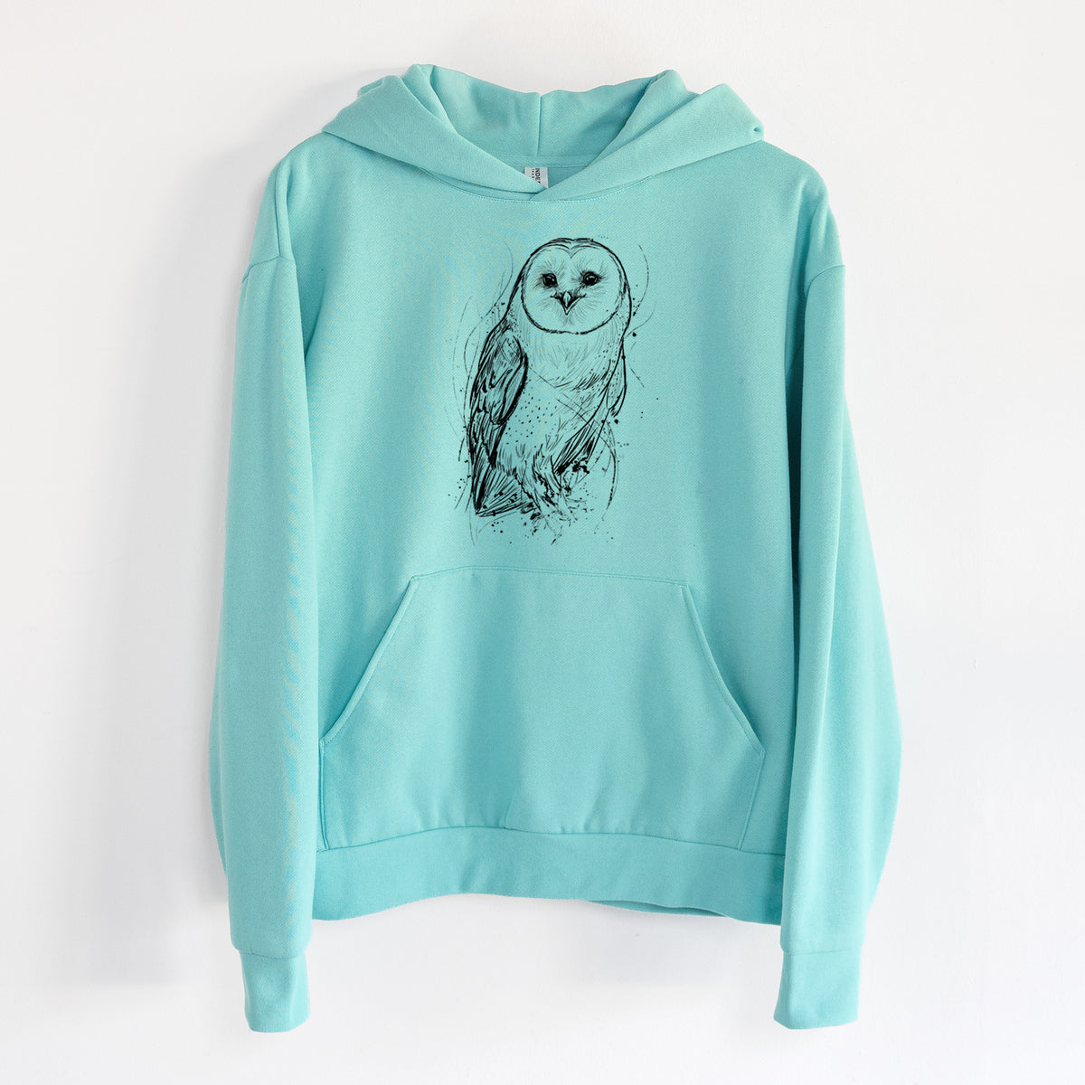 Barn Owl - Tyto alba - Statement Midweight Hoodie in Seafoam, hanging on a white wall, with a front kangaroo pocket and no drawcords.