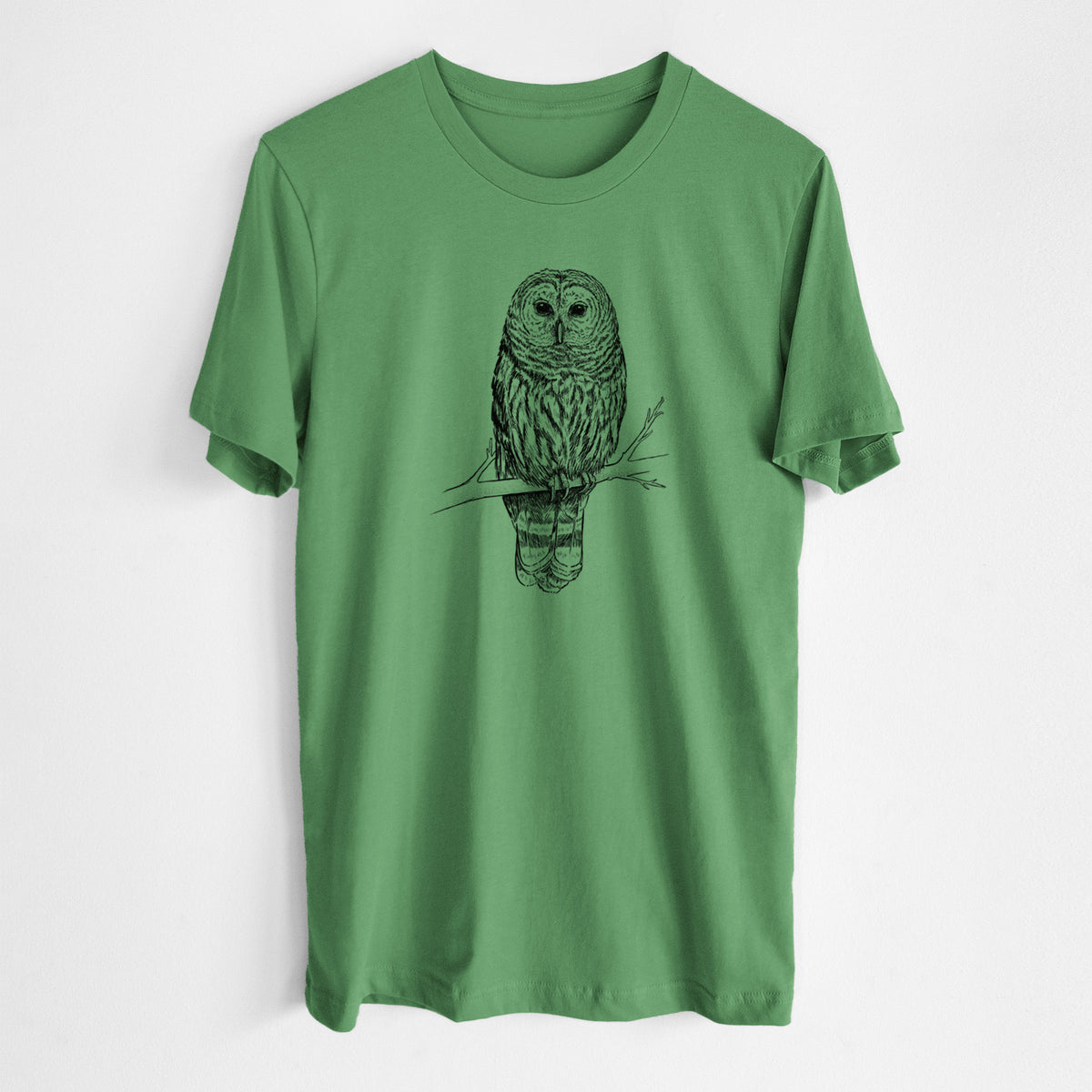 Leaf green lightweight cotton t-shirt laid flat, printed with a detailed black ink illustration of a barred owl perched on a branch.