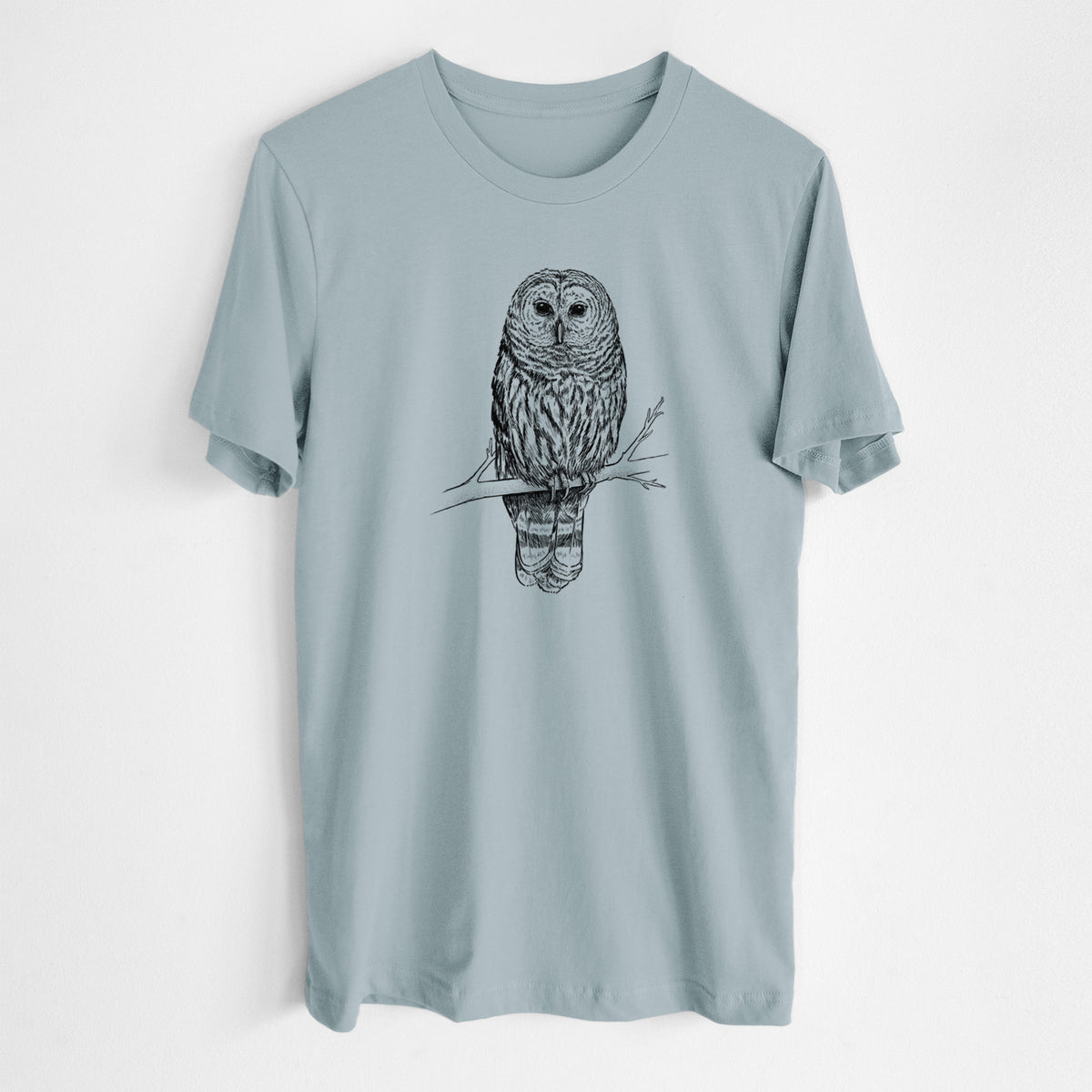 Vintage denim lightweight cotton t-shirt laid flat, printed with a detailed black ink illustration of a barred owl perched on a branch.