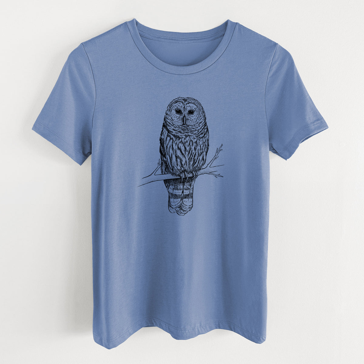 Blue bell women's relaxed fit cotton t-shirt laid flat, printed with a detailed black ink illustration of a barred owl perched on a branch.