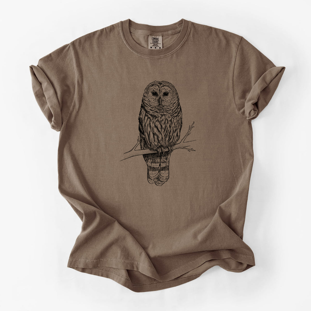 Espresso brown Comfort Colors t-shirt laid flat, printed with a detailed black ink illustration of a barred owl perched on a branch.