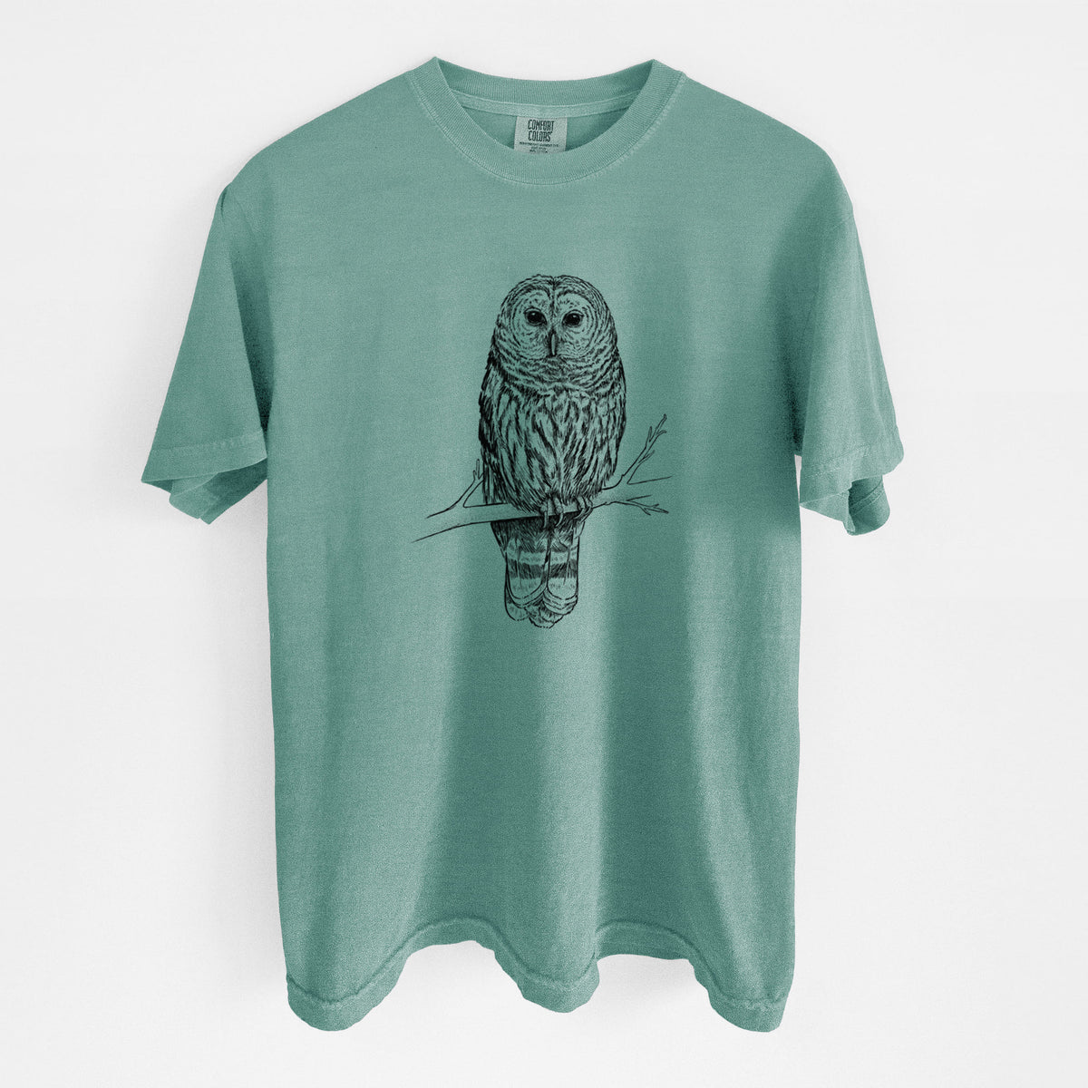 Reef green Comfort Colors t-shirt laid flat, printed with a detailed black ink illustration of a barred owl perched on a branch.