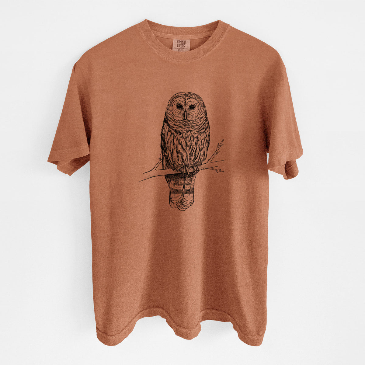Yam burnt orange Comfort Colors t-shirt laid flat, printed with a detailed black ink illustration of a barred owl perched on a branch.