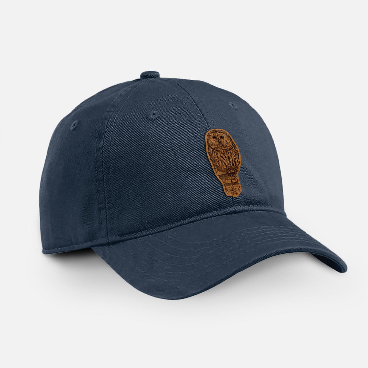 Navy cotton baseball hat with a detailed black ink illustration of a barred owl perched on a branch on the front.