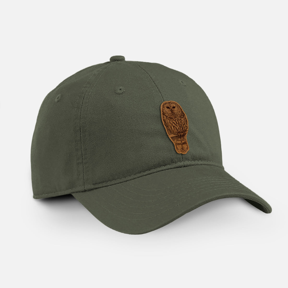 Olive cotton baseball hat with a detailed black ink illustration of a barred owl perched on a branch on the front.