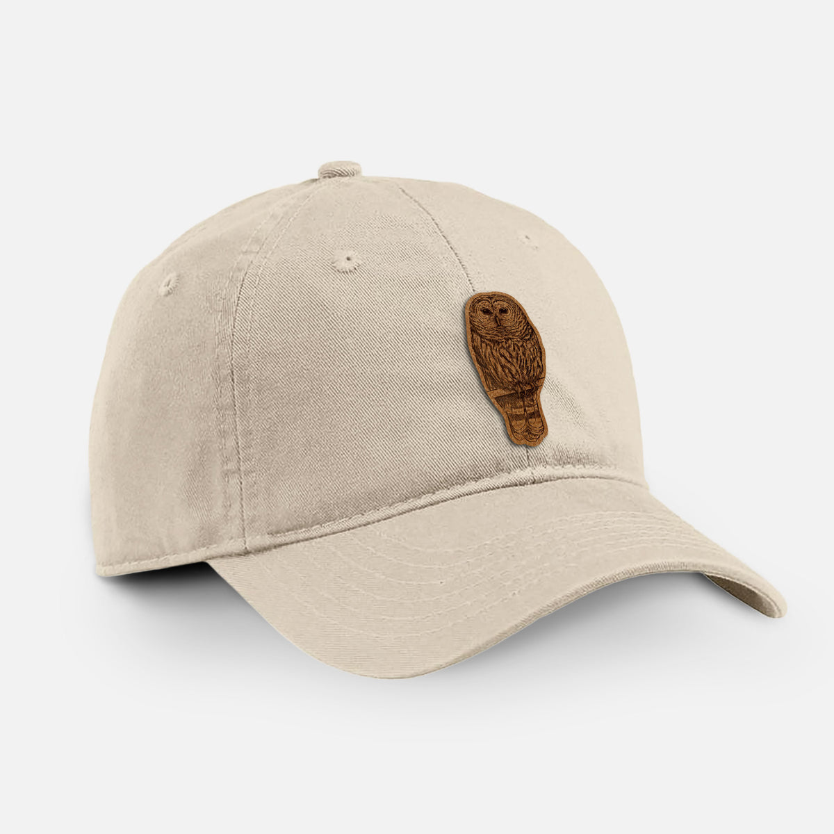 Stone cotton baseball hat with a detailed black ink illustration of a barred owl perched on a branch on the front.