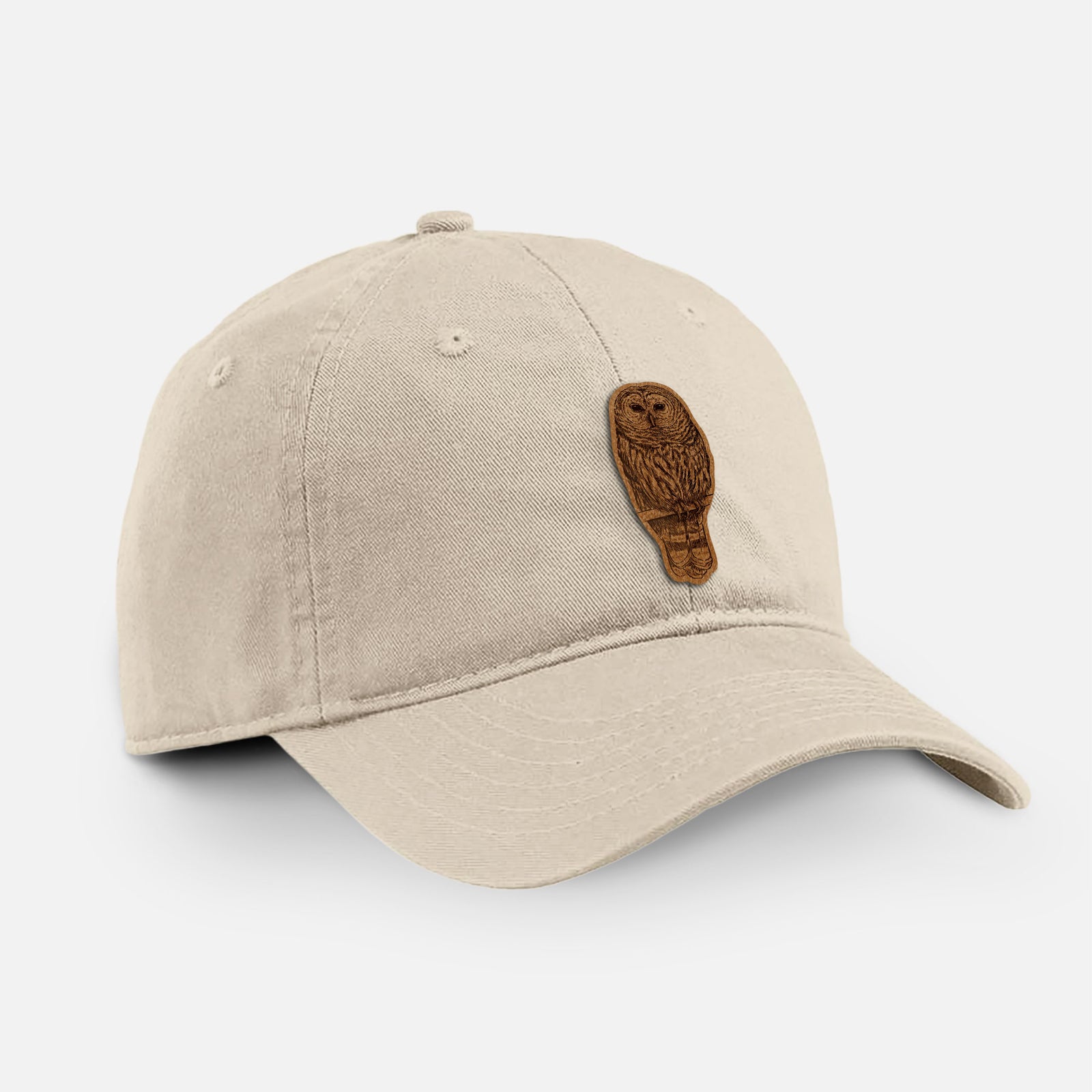 Stone cotton baseball hat with a detailed black ink illustration of a barred owl perched on a branch on the front.