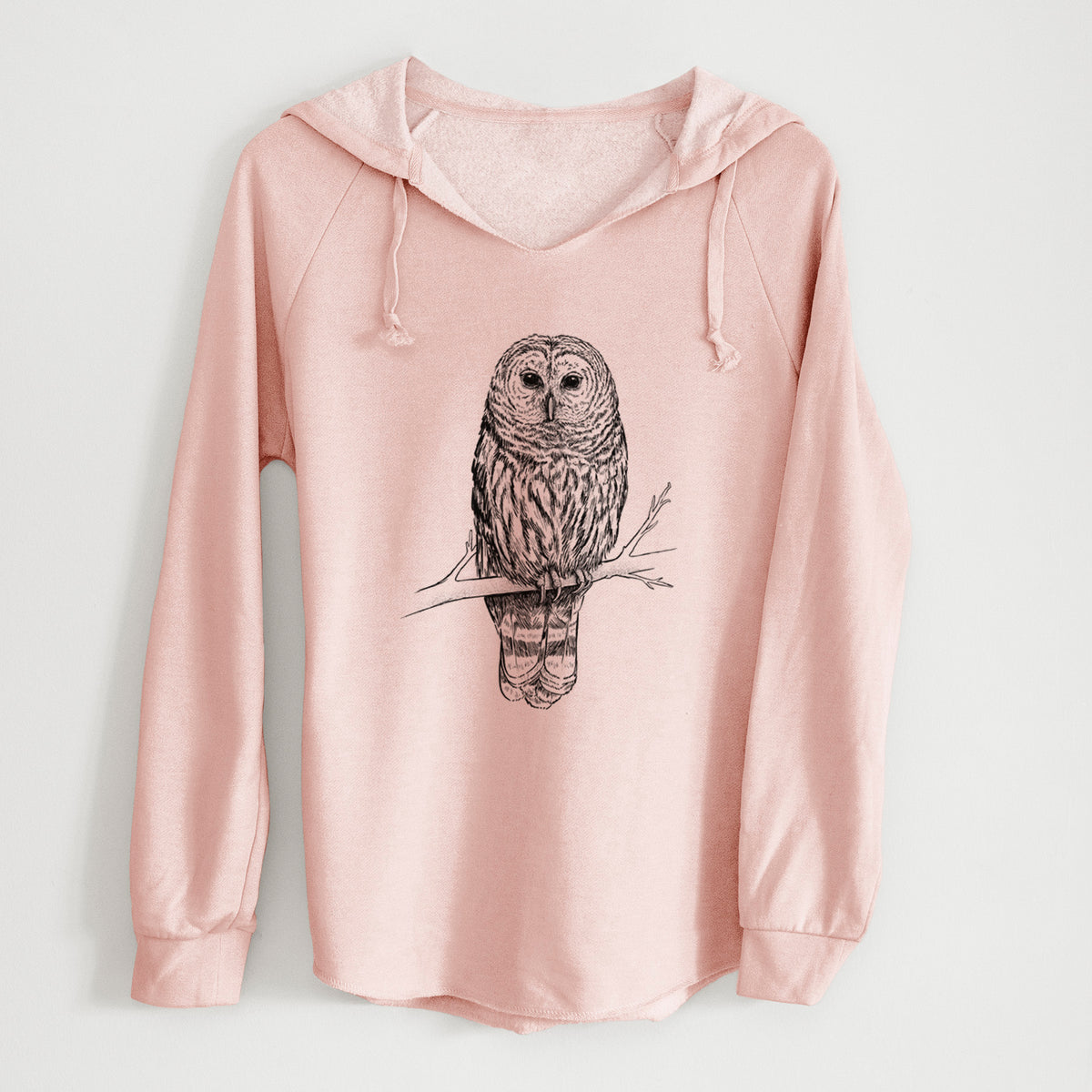 Blush pink women's Cali Wave hooded sweatshirt laid flat, printed with a detailed black ink illustration of a barred owl perched on a branch.