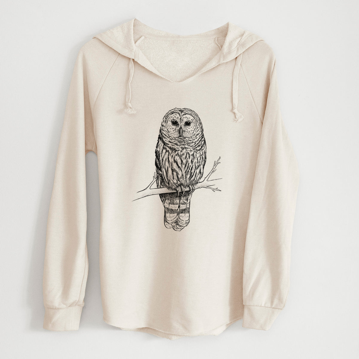 Bone cream women's Cali Wave hooded sweatshirt laid flat, printed with a detailed black ink illustration of a barred owl perched on a branch.