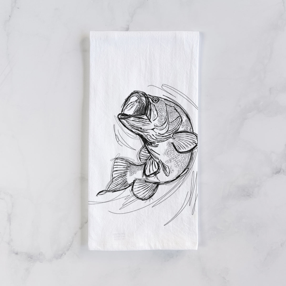 White cotton tea towel laid flat on marble, printed with a detailed black ink illustration of a largemouth bass leaping with its mouth open.