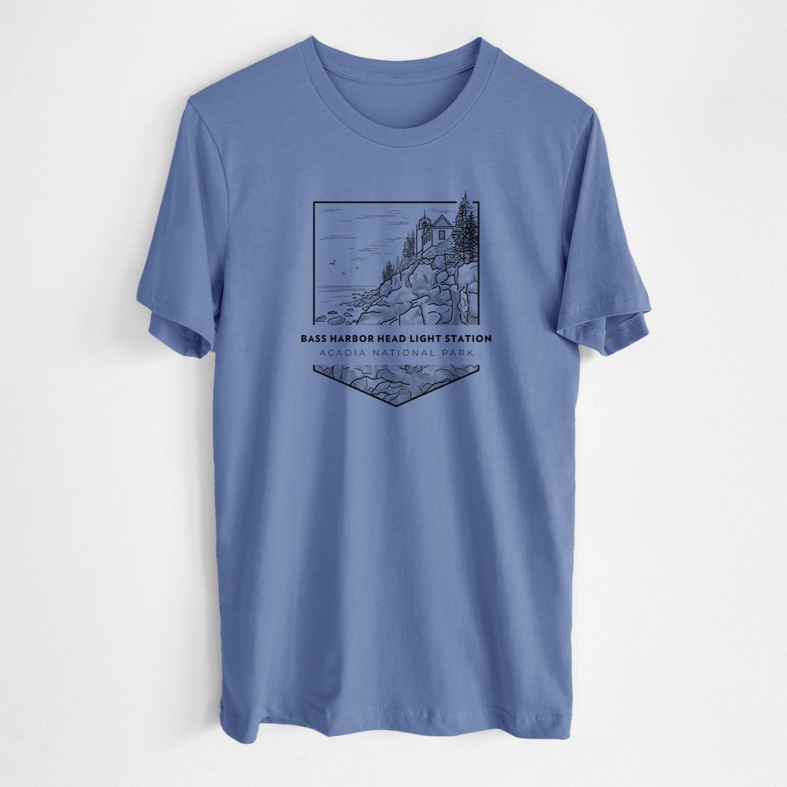 Blue bell lightweight cotton t-shirt laid flat, printed with a black line art badge of Bass Harbor Head Light Station on a rocky cliff, with the words Acadia National Park.