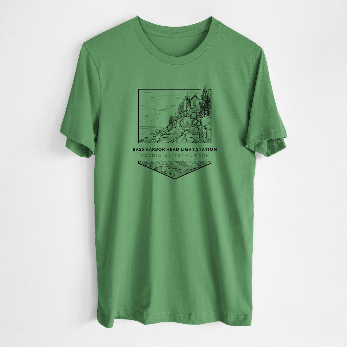 Leaf green lightweight cotton t-shirt laid flat, printed with a black line art badge of Bass Harbor Head Light Station on a rocky cliff, with the words Acadia National Park.
