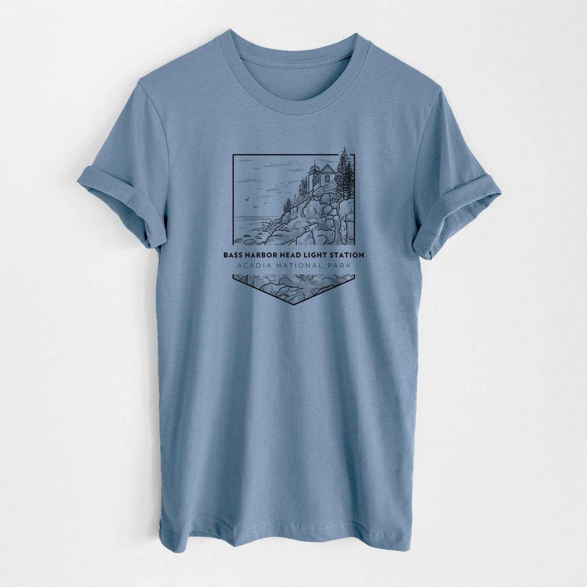 Steel blue lightweight cotton t-shirt laid flat, printed with a black line art badge of Bass Harbor Head Light Station on a rocky cliff, with the words Acadia National Park.
