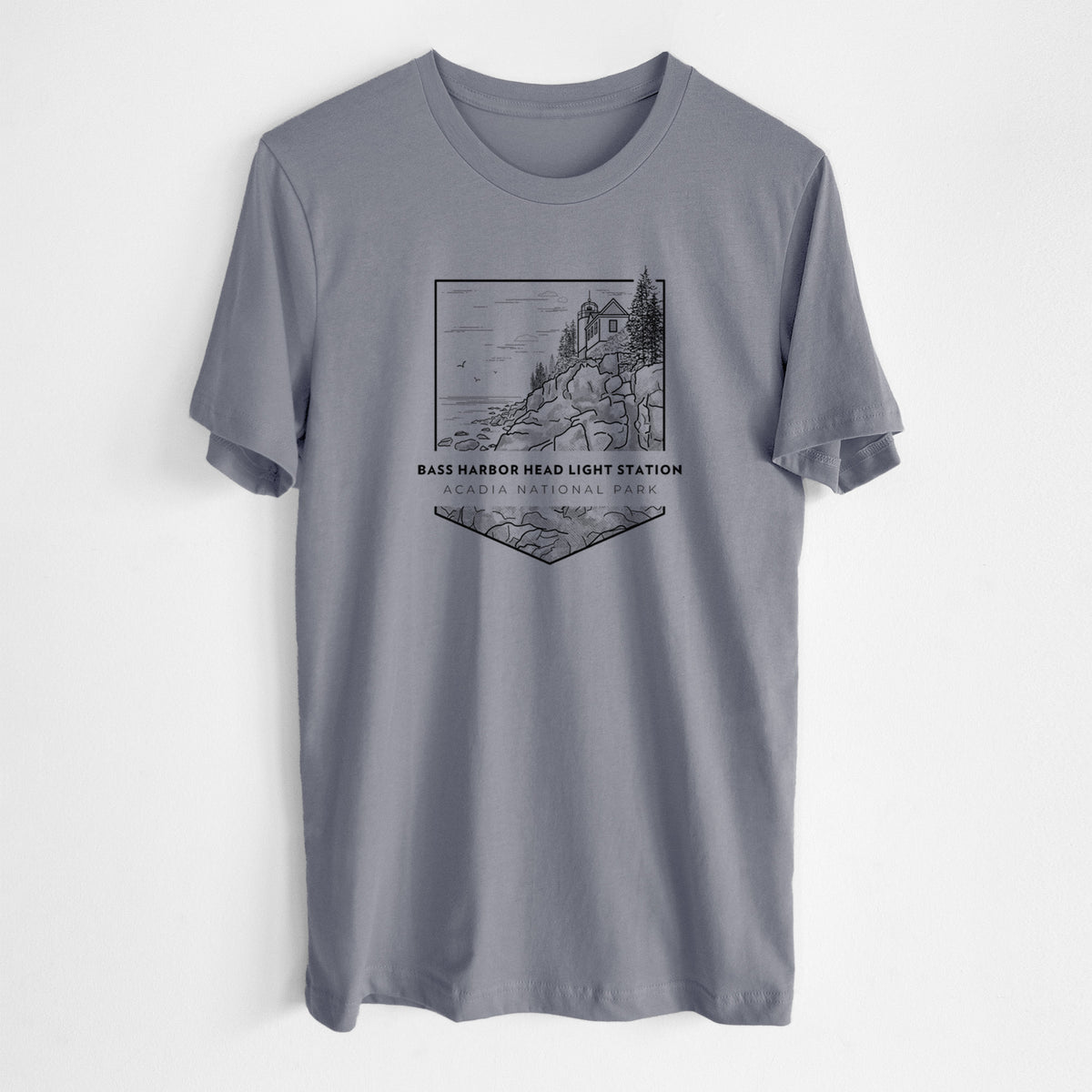 Storm grey lightweight cotton t-shirt laid flat, printed with a black line art badge of Bass Harbor Head Light Station on a rocky cliff, with the words Acadia National Park.