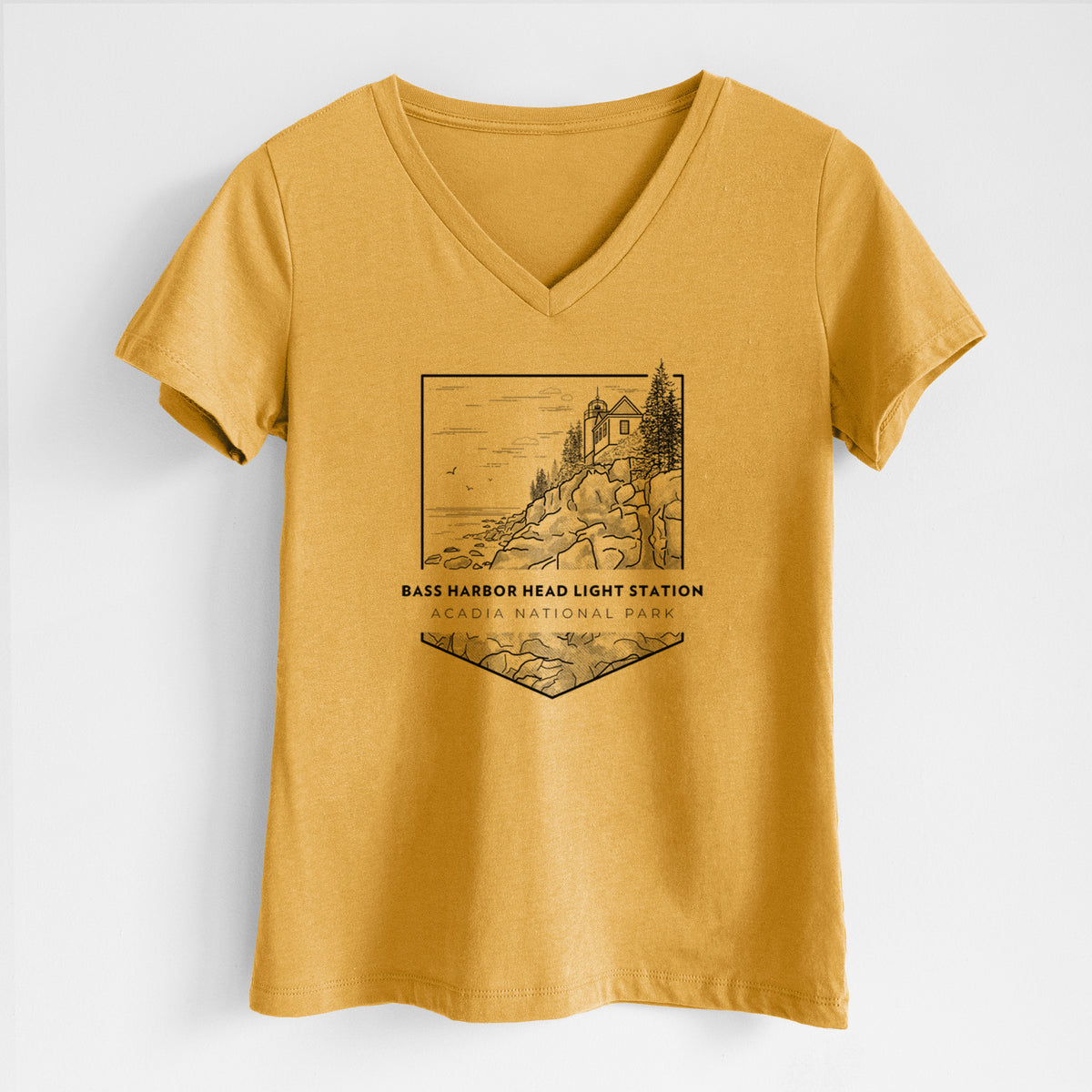 Honeycomb yellow women's relaxed fit cotton V-neck t-shirt laid flat, printed with a black line art badge of Bass Harbor Head Light Station on a rocky cliff, with the words Acadia National Park.