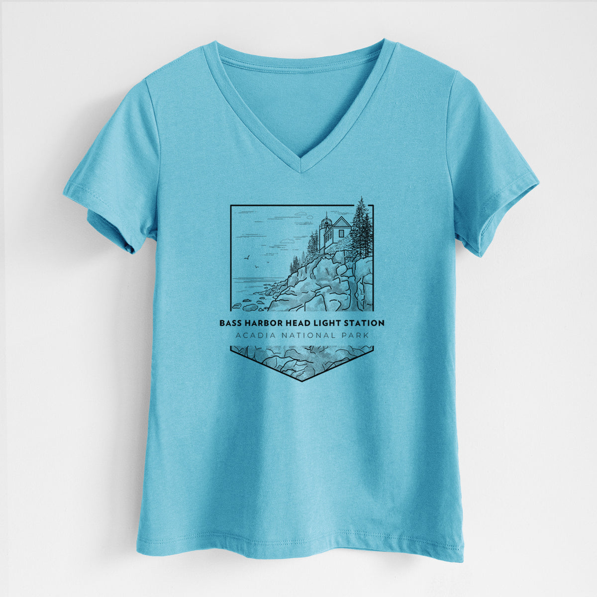 Turquoise women's relaxed fit cotton V-neck t-shirt laid flat, printed with a black line art badge of Bass Harbor Head Light Station on a rocky cliff, with the words Acadia National Park.