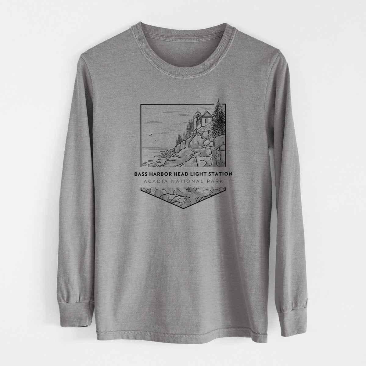 Grey Comfort Colors long sleeve shirt laid flat, printed with a black line art badge of Bass Harbor Head Light Station on a rocky cliff, with the words Acadia National Park.