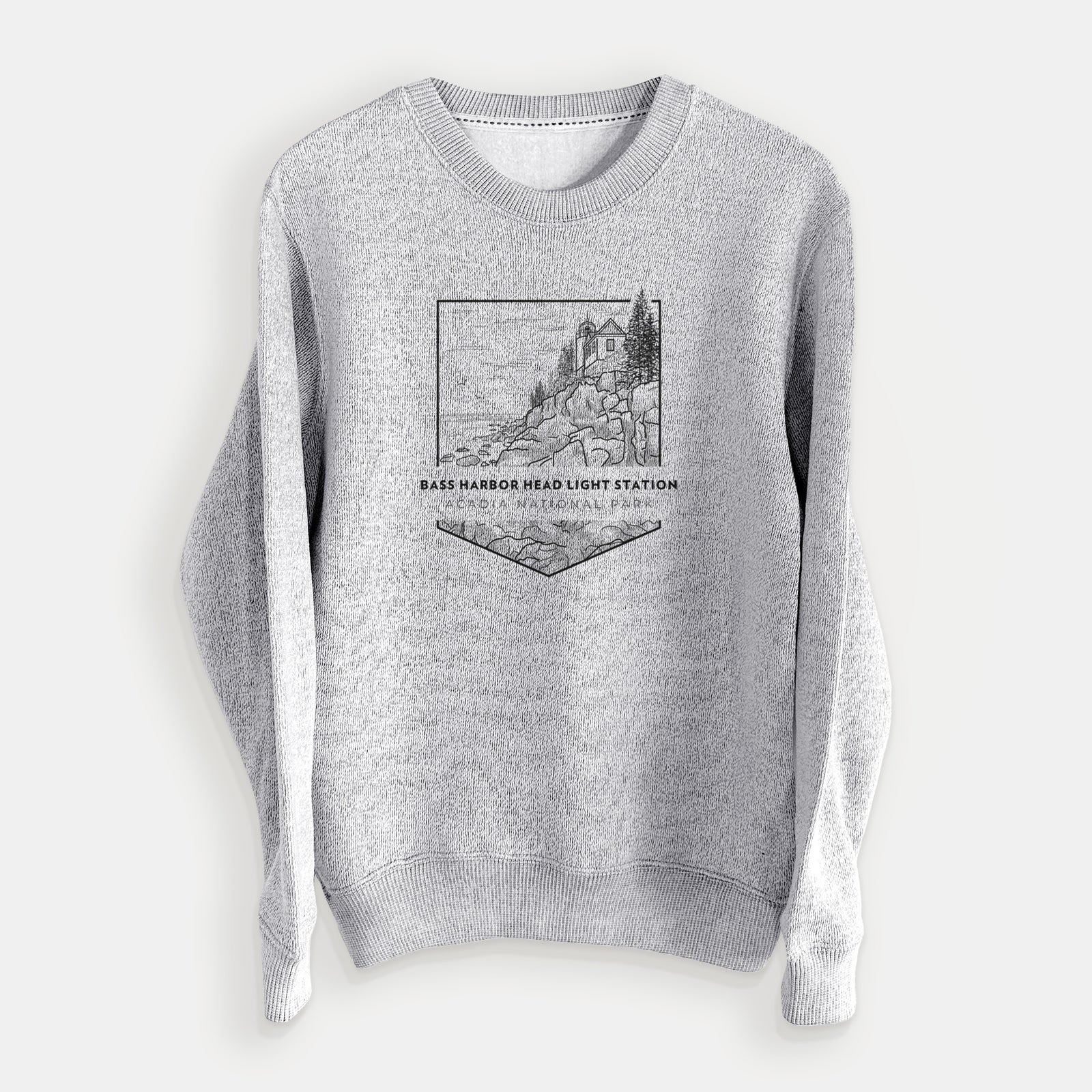 Salt and pepper knit sweatshirt laid flat, printed with a black line art badge of Bass Harbor Head Light Station on a rocky cliff, with the words Acadia National Park.
