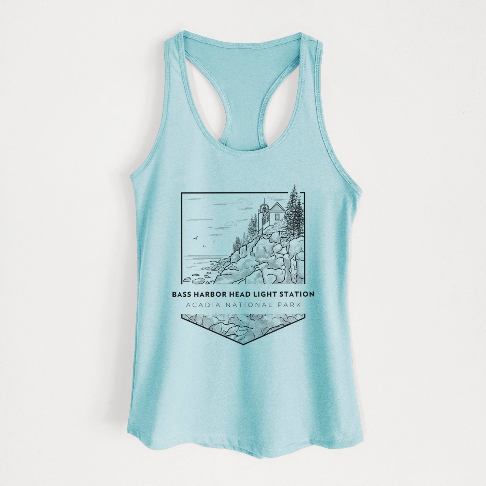 Banana cream women's racerback tank top laid flat, printed with a black line art badge of Bass Harbor Head Light Station on a rocky cliff, with the words Acadia National Park.