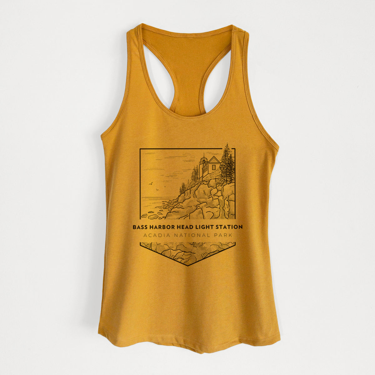 Gold women's racerback tank top laid flat, printed with a black line art badge of Bass Harbor Head Light Station on a rocky cliff, with the words Acadia National Park.