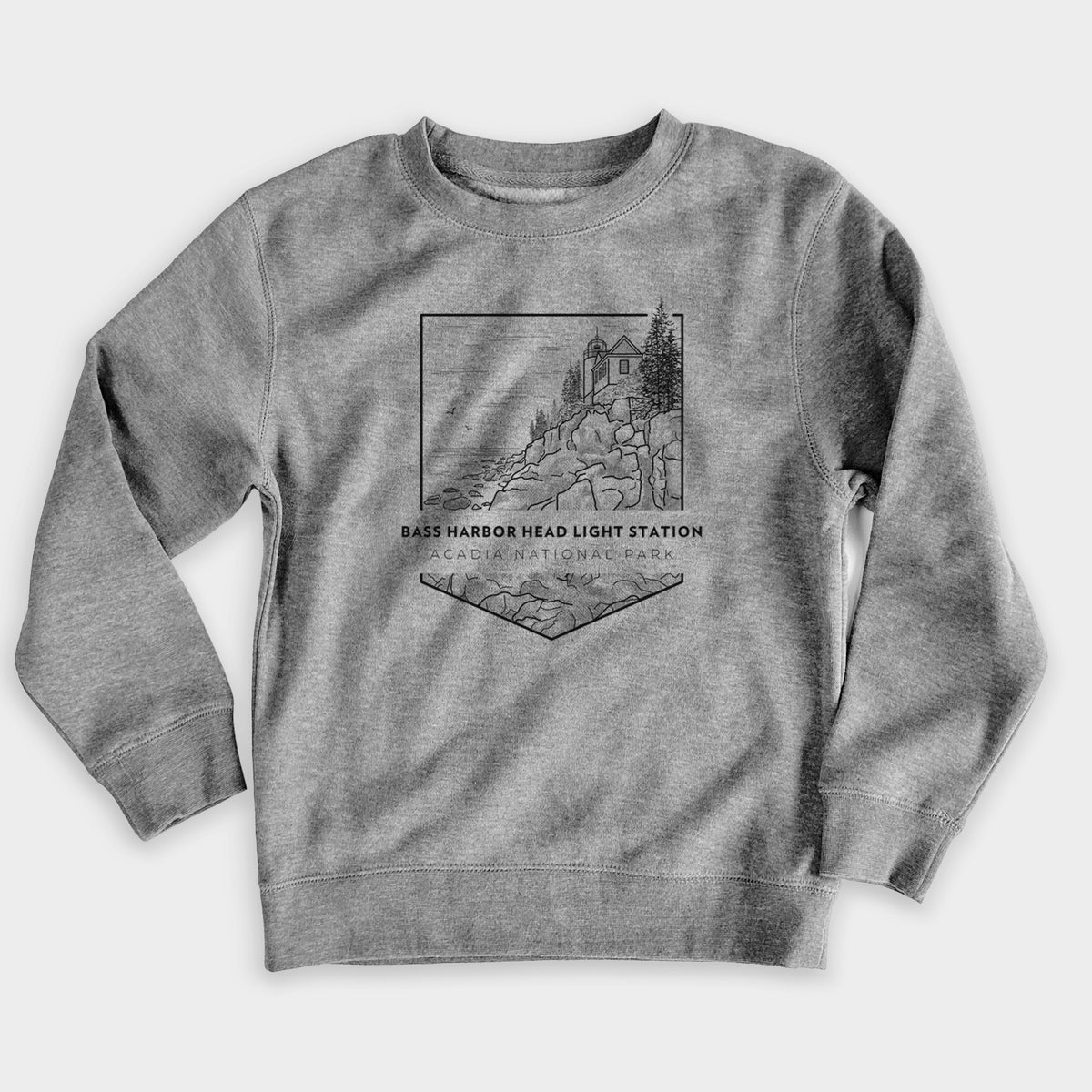Nickel grey youth crewneck sweatshirt laid flat, printed with a black line art badge of Bass Harbor Head Light Station on a rocky cliff, with the words Acadia National Park.