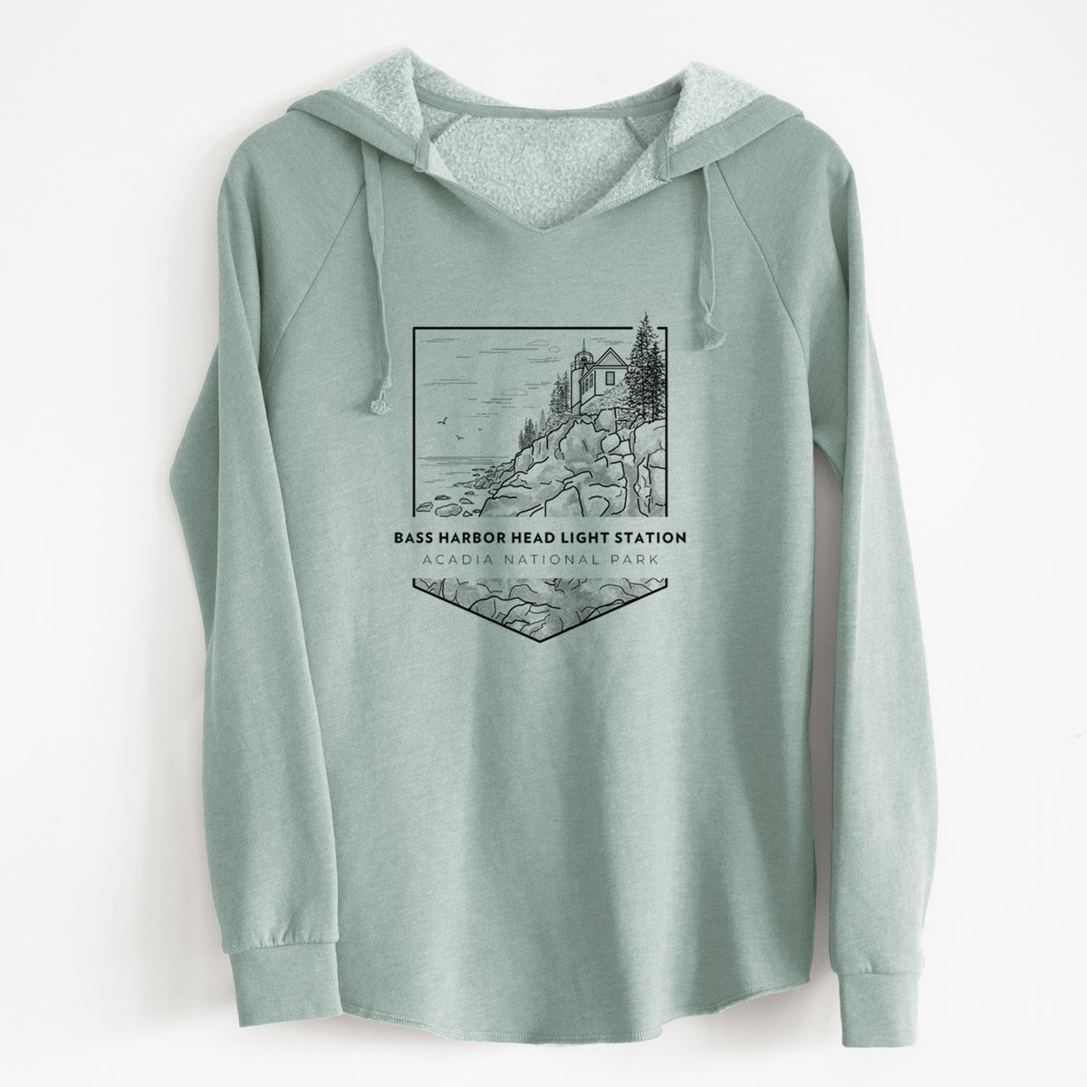 Sage green women's Cali Wave hooded sweatshirt laid flat, printed with a black line art badge of Bass Harbor Head Light Station on a rocky cliff, with the words Acadia National Park.