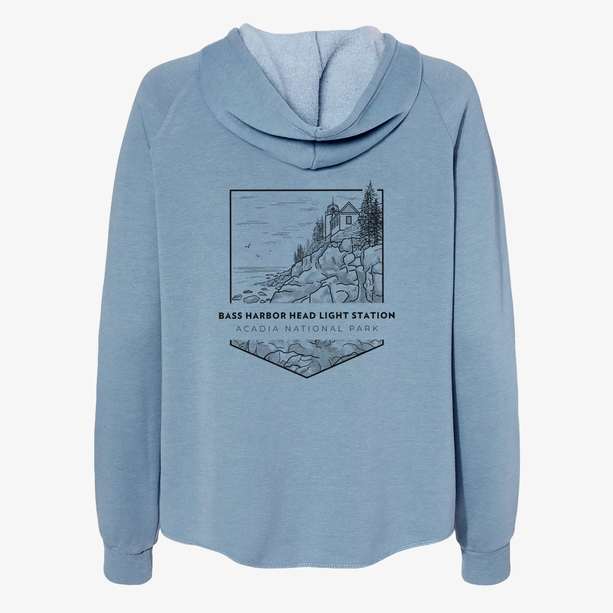 Misty blue women's Cali Wave zip-up sweatshirt laid flat, printed with a black line art badge of Bass Harbor Head Light Station on a rocky cliff, with the words Acadia National Park.