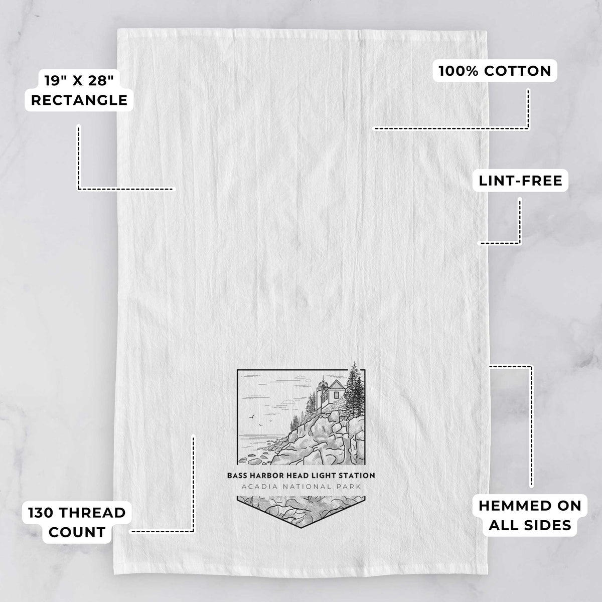White tea towel printed with a black line art badge of Bass Harbor Head Light Station on a rocky cliff, with the words Acadia National Park, with feature labels: 19 by 28 inch rectangle, 100% cotton, lint-free, 130 thread count, hemmed on all sides.