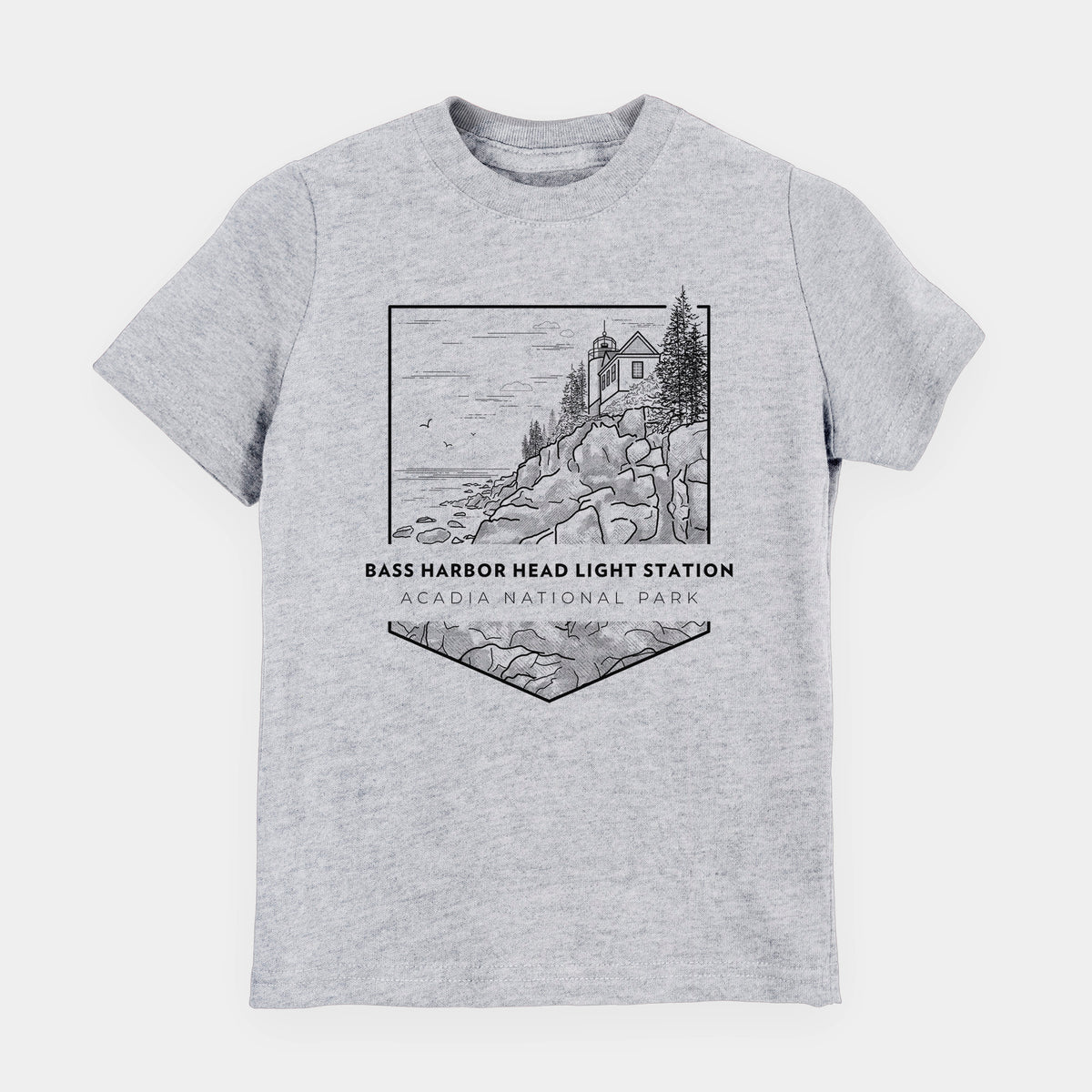 Heather grey youth t-shirt laid flat, printed with a black line art badge of Bass Harbor Head Light Station on a rocky cliff, with the words Acadia National Park.