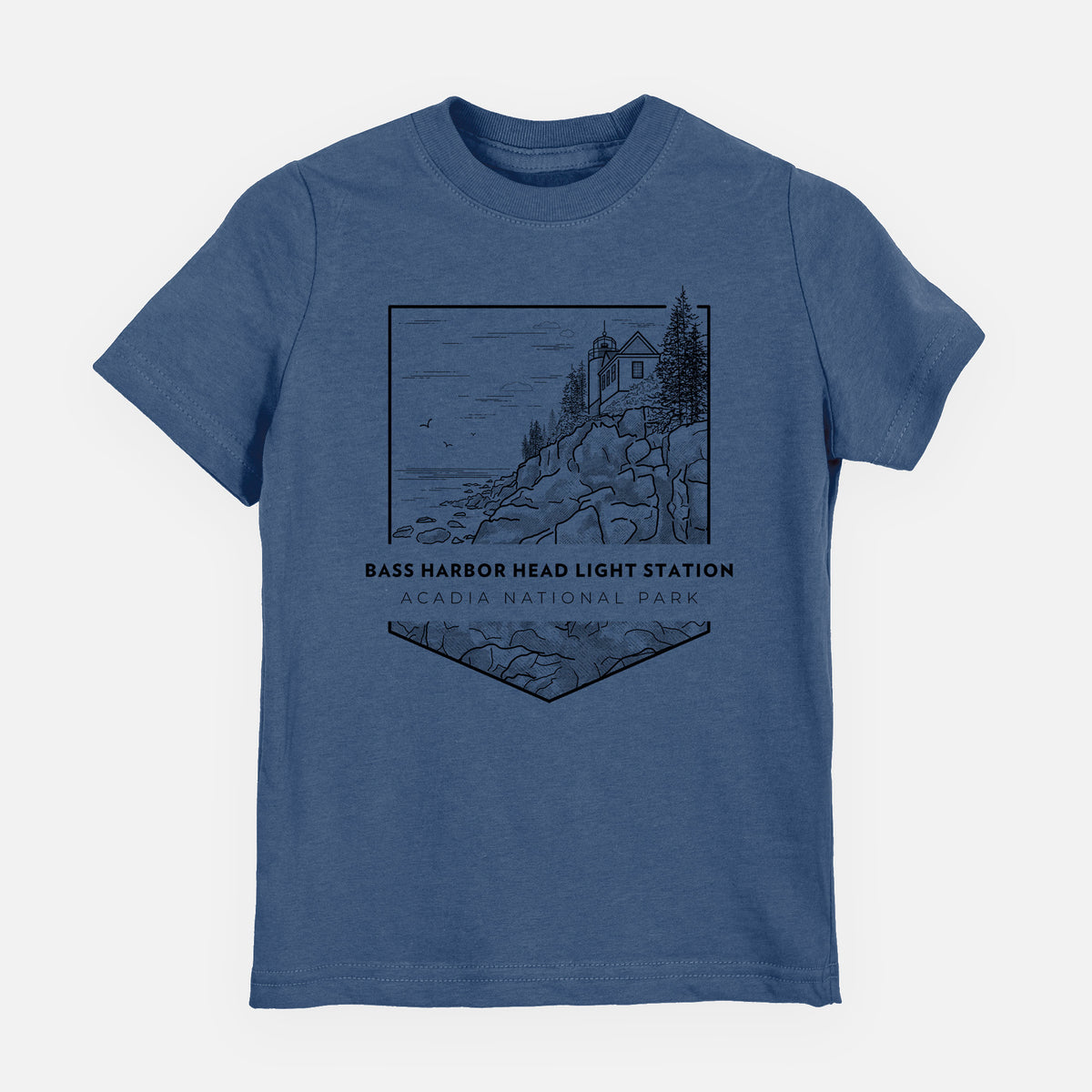 Indigo blue youth t-shirt laid flat, printed with a black line art badge of Bass Harbor Head Light Station on a rocky cliff, with the words Acadia National Park.