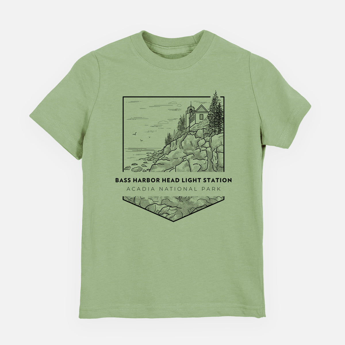 Sage green youth t-shirt laid flat, printed with a black line art badge of Bass Harbor Head Light Station on a rocky cliff, with the words Acadia National Park.