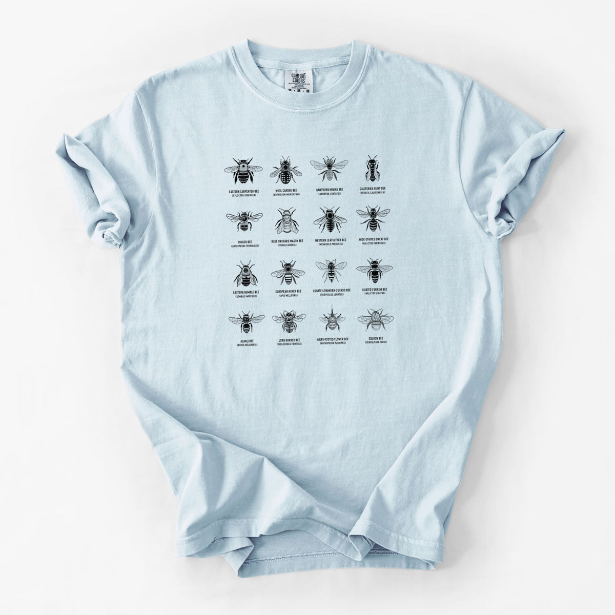 Chambray blue Comfort Colors t-shirt laid flat, printed with a chart of black ink illustrations of different bee species with their names.