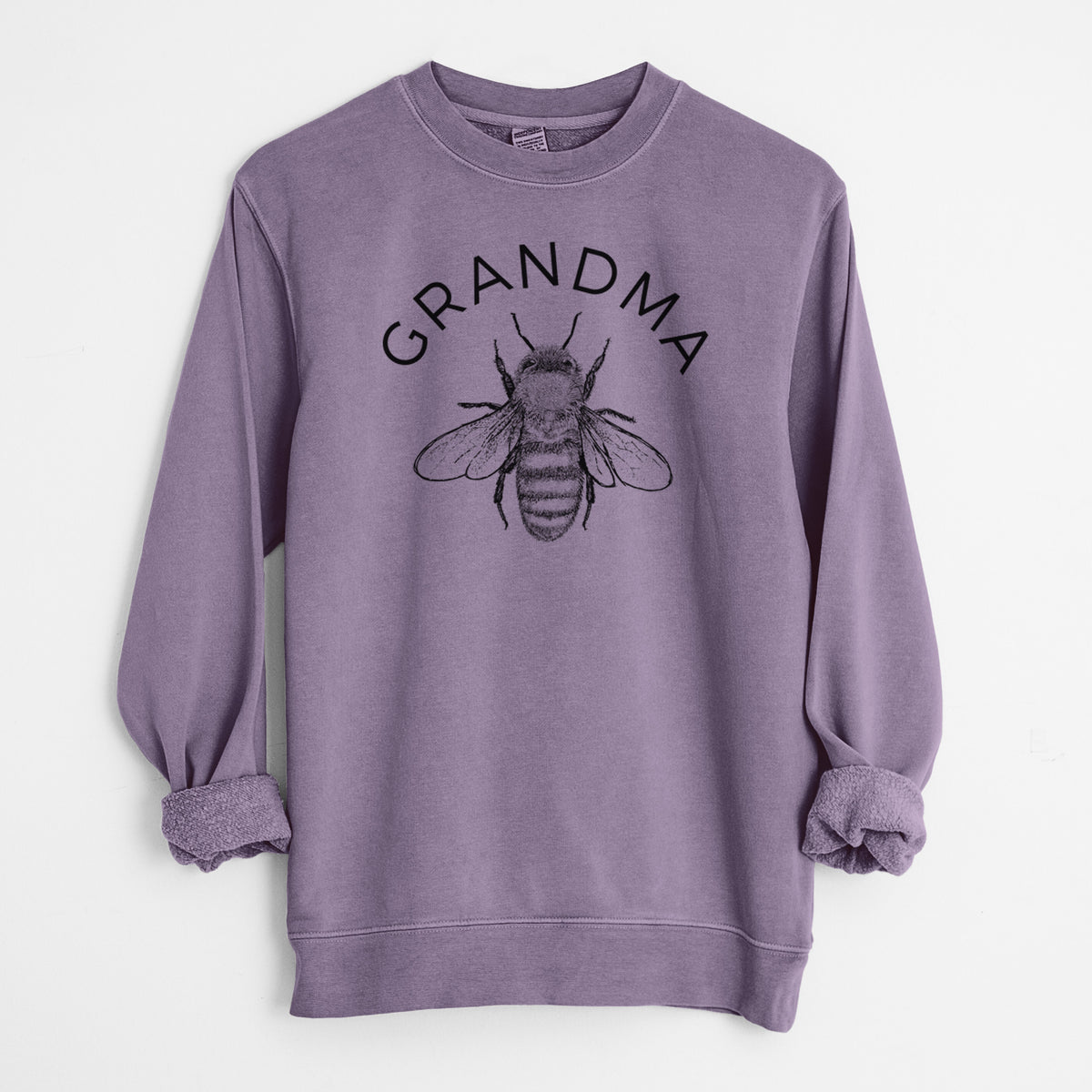 Plum purple pigment dyed crewneck sweatshirt laid flat with the sleeves rolled, printed with a black ink honey bee beneath the word Grandma.