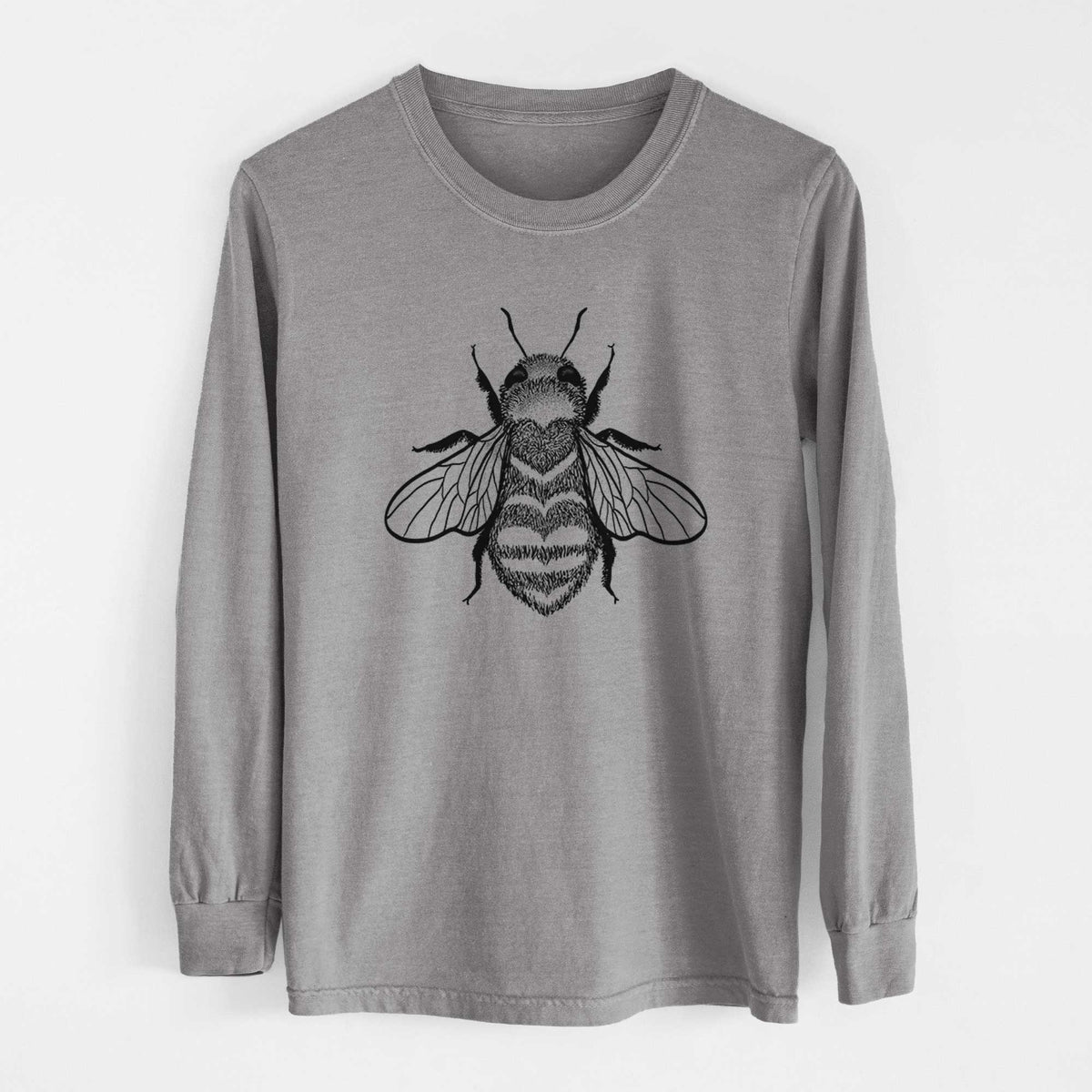 Grey Comfort Colors long sleeve shirt laid flat, printed with a black ink bee with a heart pattern on its body.