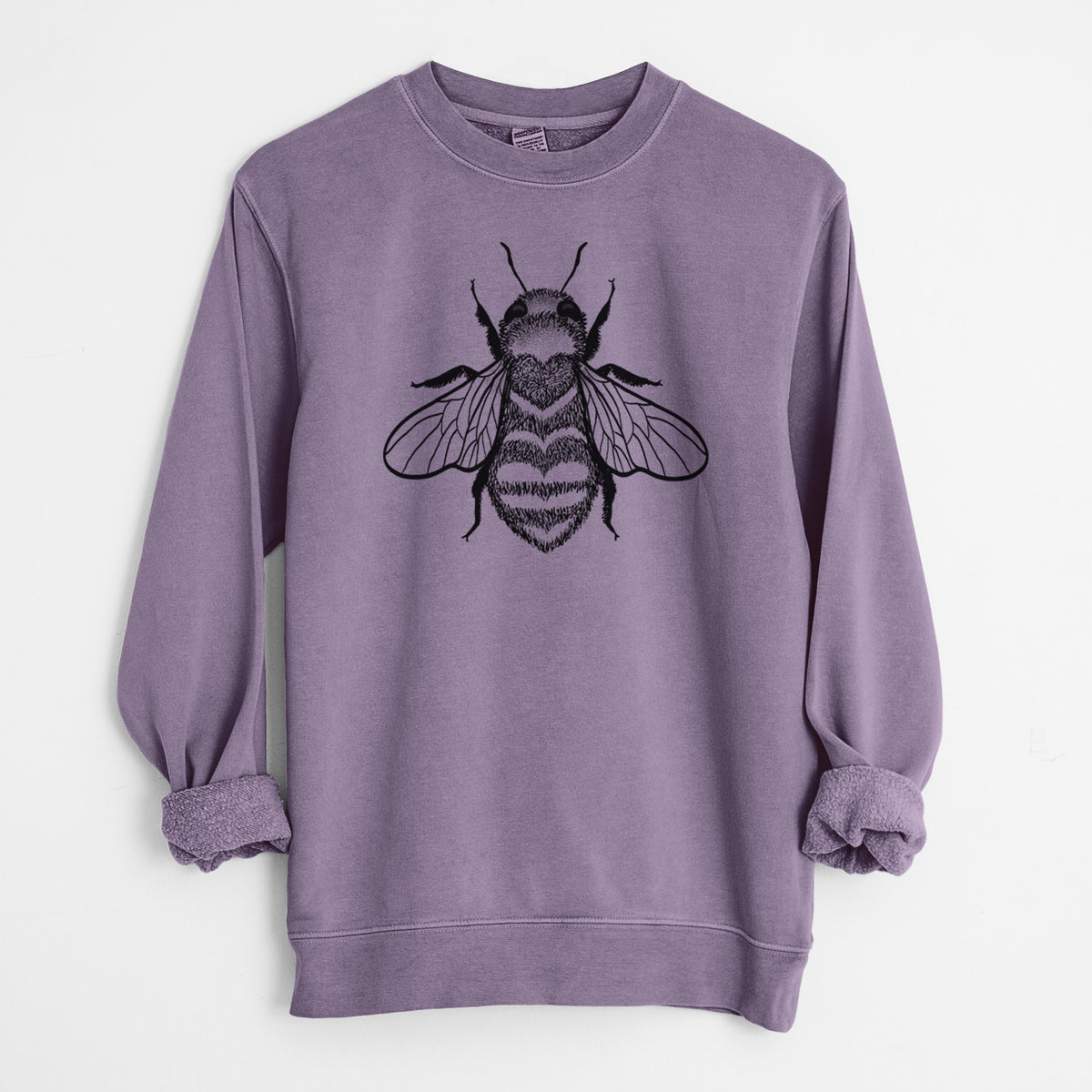 Plum purple pigment dyed crewneck sweatshirt laid flat with the sleeves rolled, printed with a black ink bee with a heart pattern on its body.