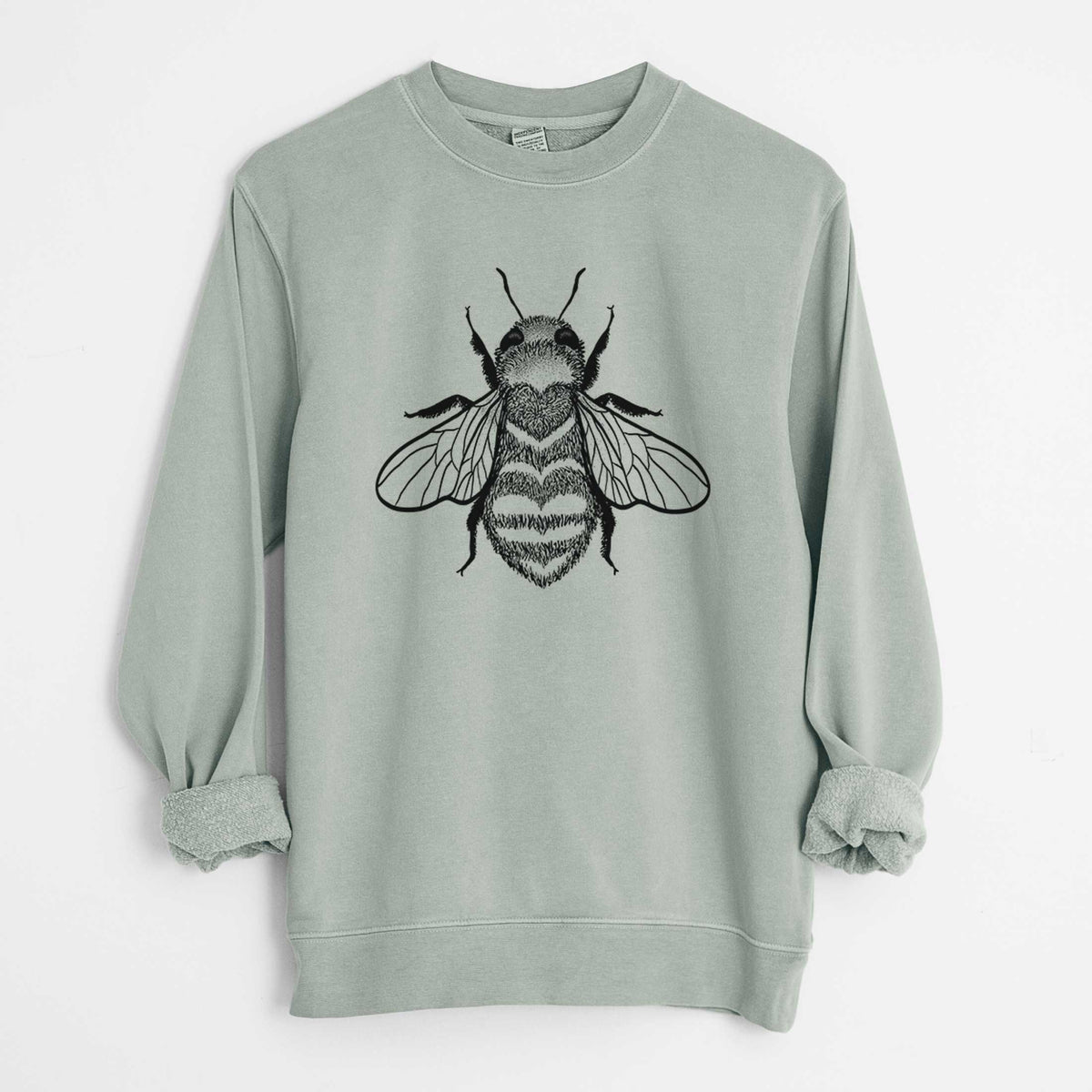 Sage green pigment dyed crewneck sweatshirt laid flat with the sleeves rolled, printed with a black ink bee with a heart pattern on its body.