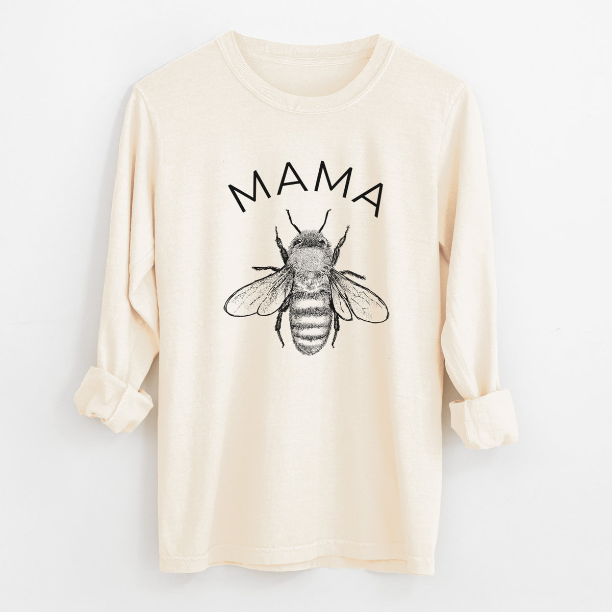 Ivory Comfort Colors long sleeve shirt laid flat with the cuffs rolled, printed with a black ink honey bee beneath the word Mama.