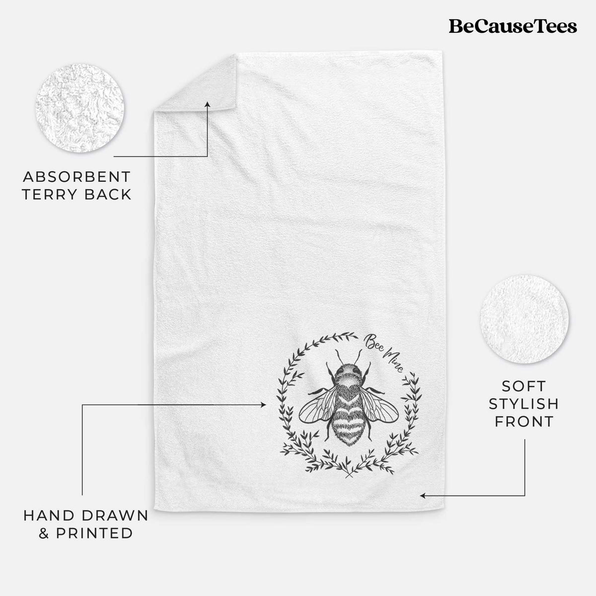 White hand towel printed with a black ink bee inside a wreath of leaves with the words Bee Mine.