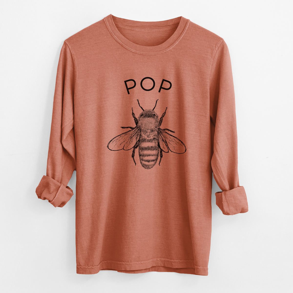 Yam burnt orange Comfort Colors long sleeve shirt laid flat with the cuffs rolled, printed with a black ink honey bee beneath the word Pop.