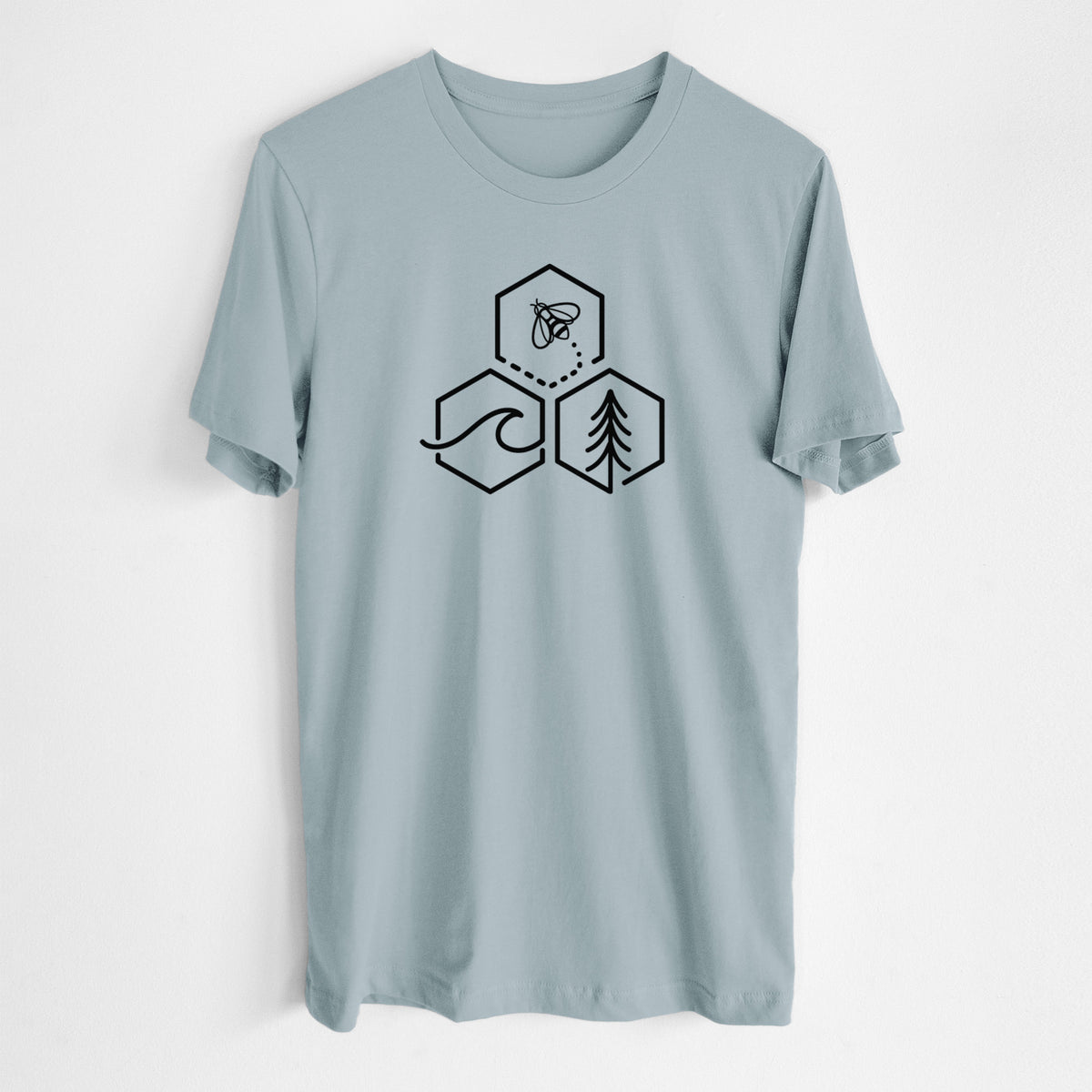 Vintage denim lightweight cotton t-shirt laid flat, printed with a black line art design of three hexagons holding a bee, an ocean wave and a pine tree.